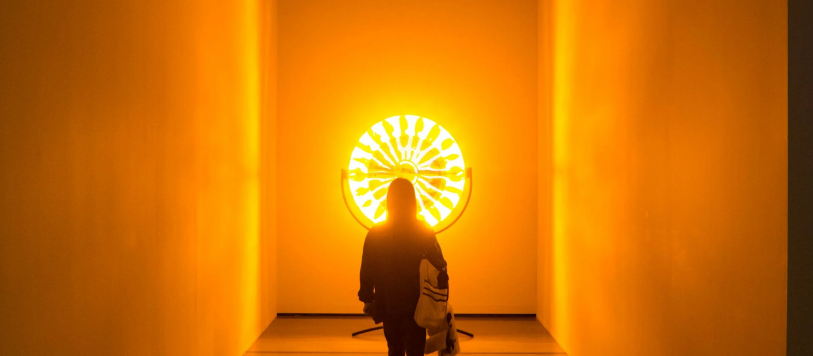 a woman standing in front of a bright light