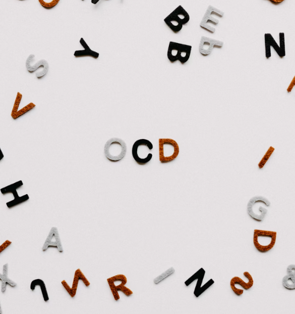 An image with the letters OCD in the center. The background is white and there are other letters surrounding the center.