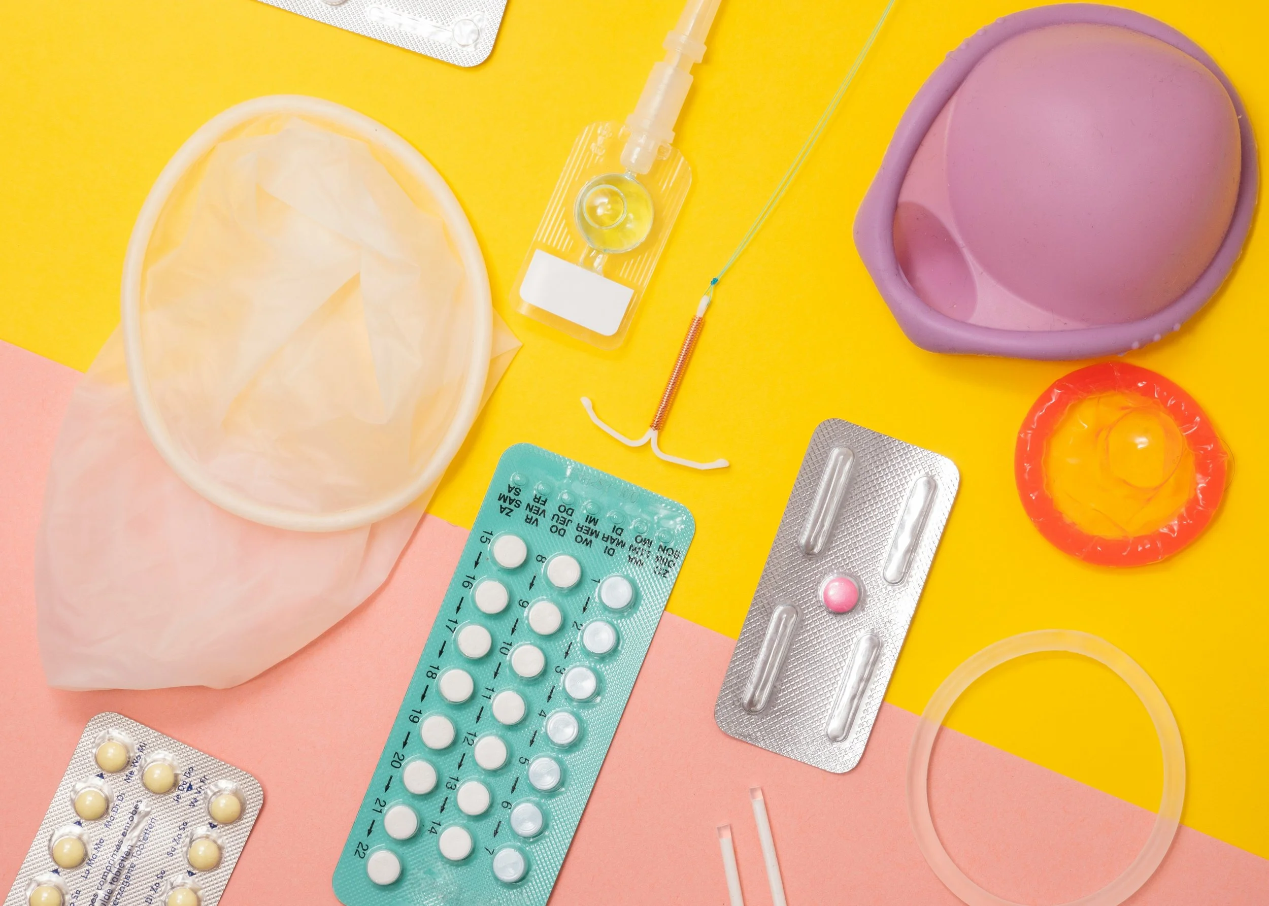 multiple forms of birth control spread out over a yellow and pink background
