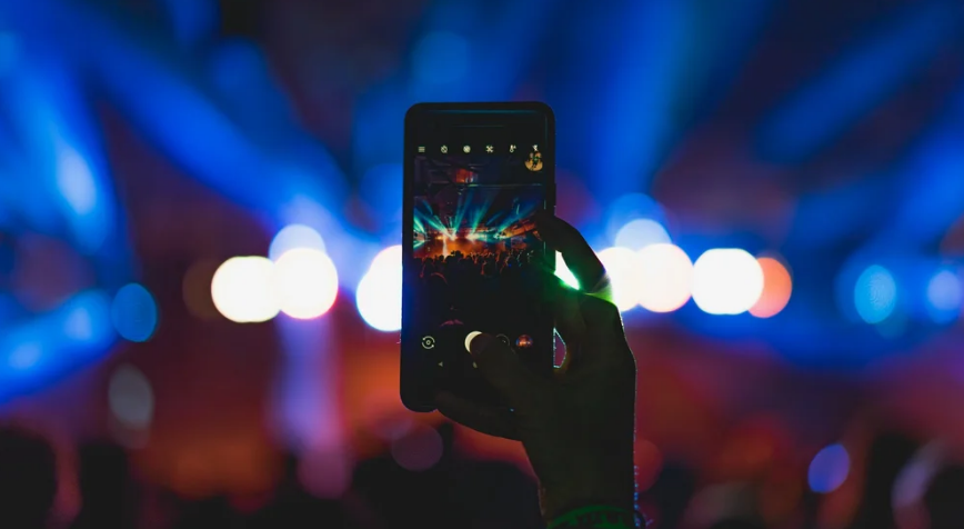 An image of a phone taking pictures at a concert of the lightshow