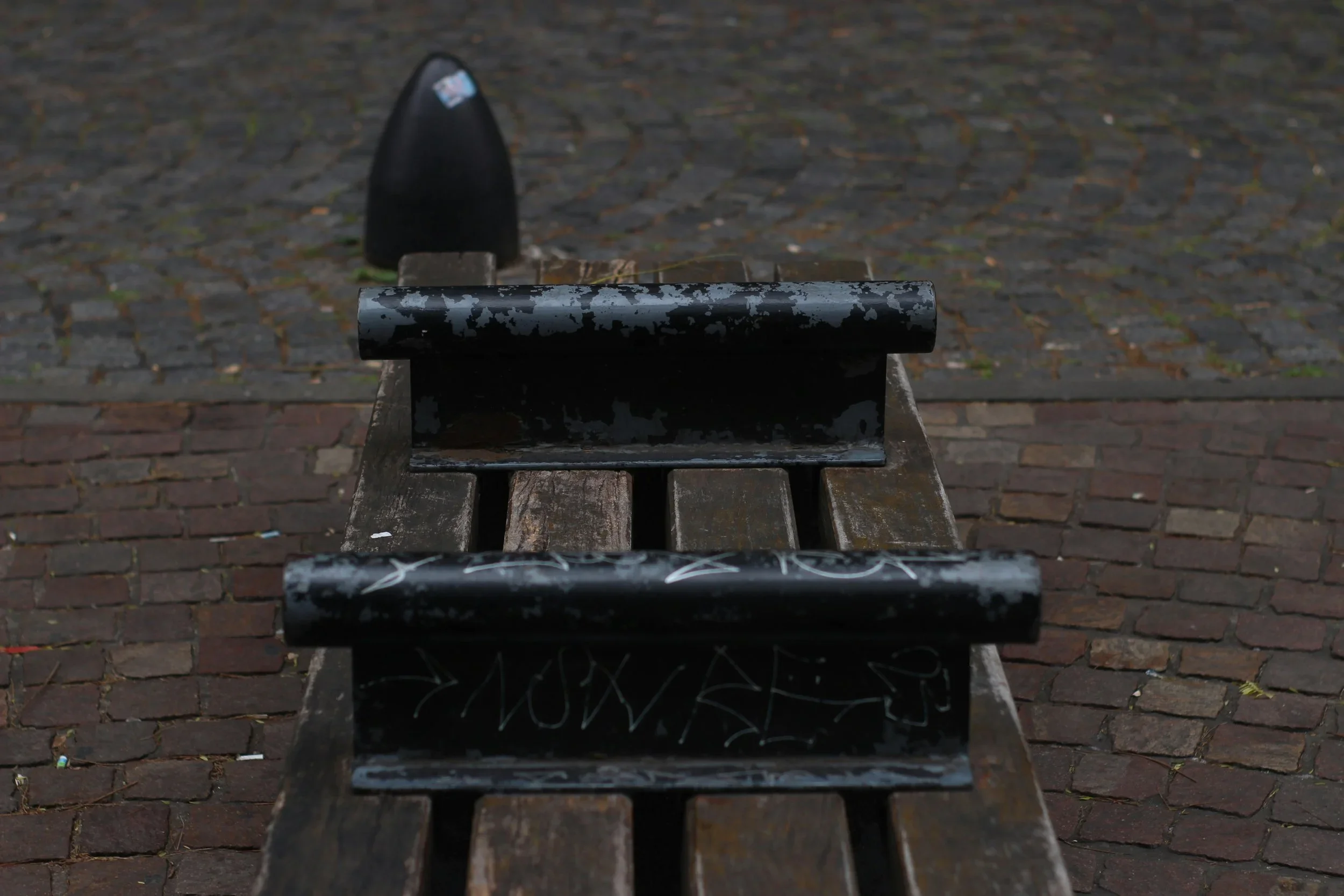 A bench with arm bars on top.