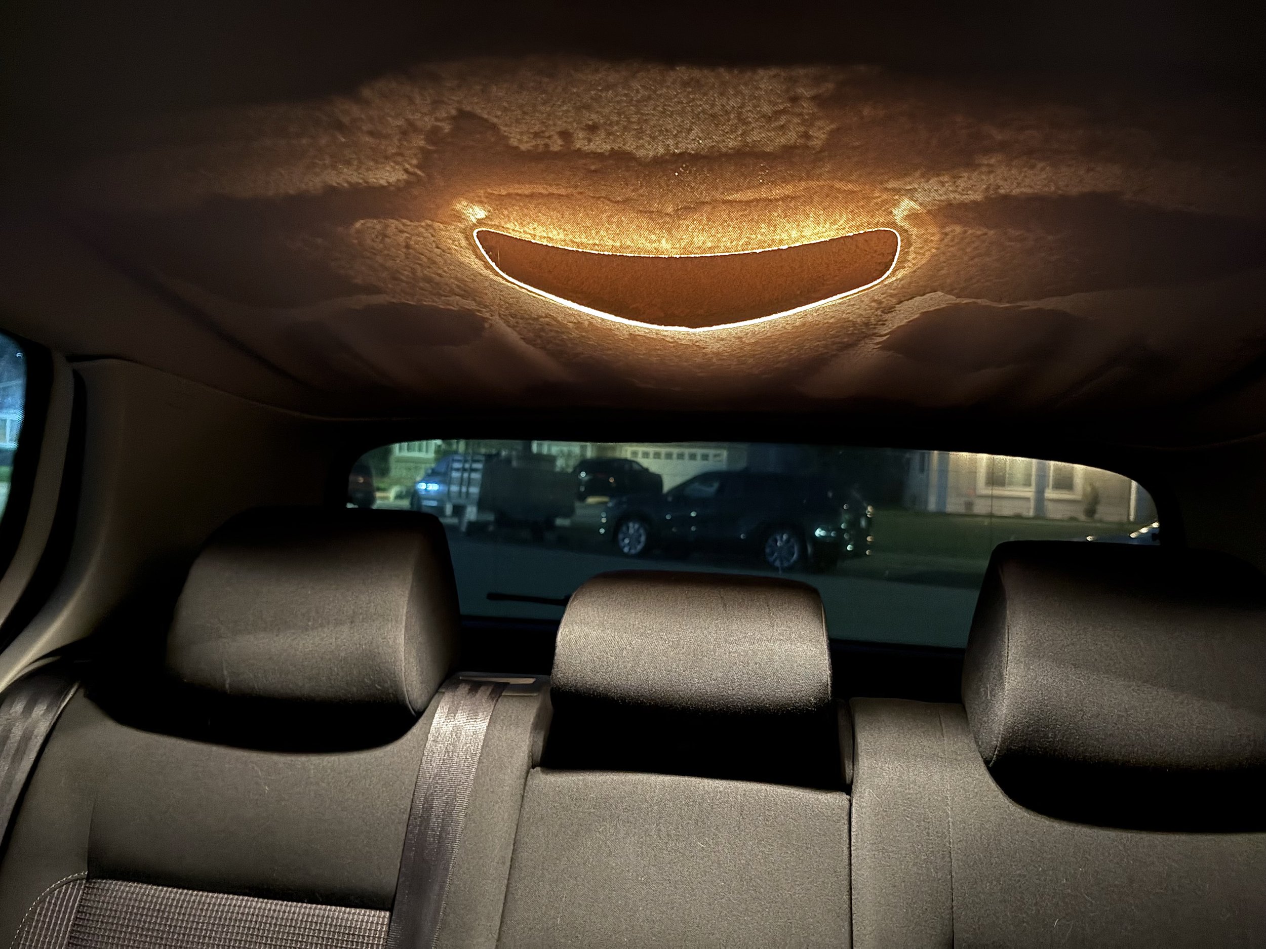 backseat of a car with the roof caving in