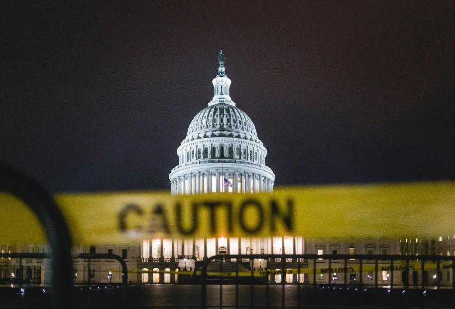 Image of government building with caution tape across it