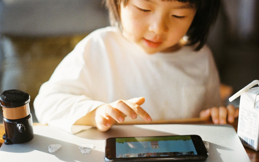 a child playing a game on a cell phone
