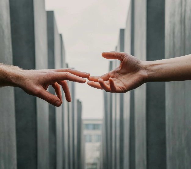 Two hands reaching for each other.