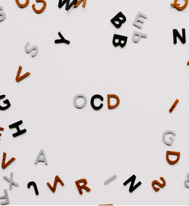 A photo with a white background and random letters on the outer part. The center of the photo says OCD.
