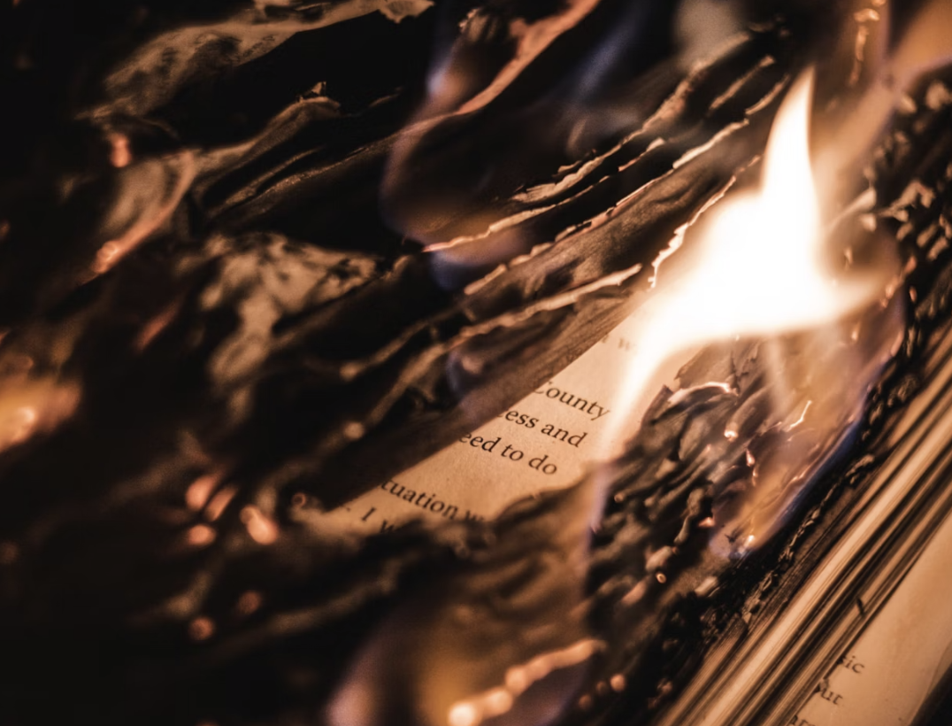 A photo of the pages of a book burning
