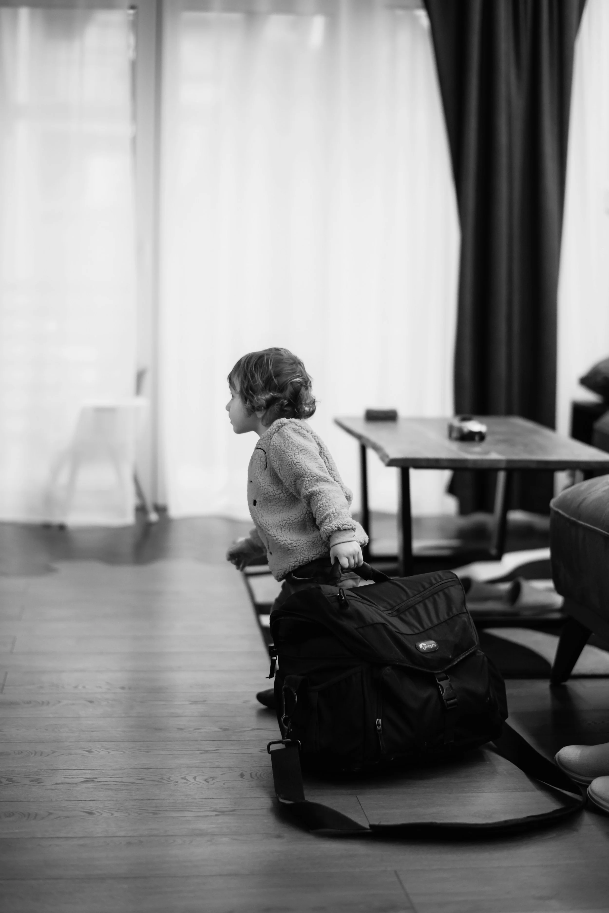 a child carrying a backpack leaving the place