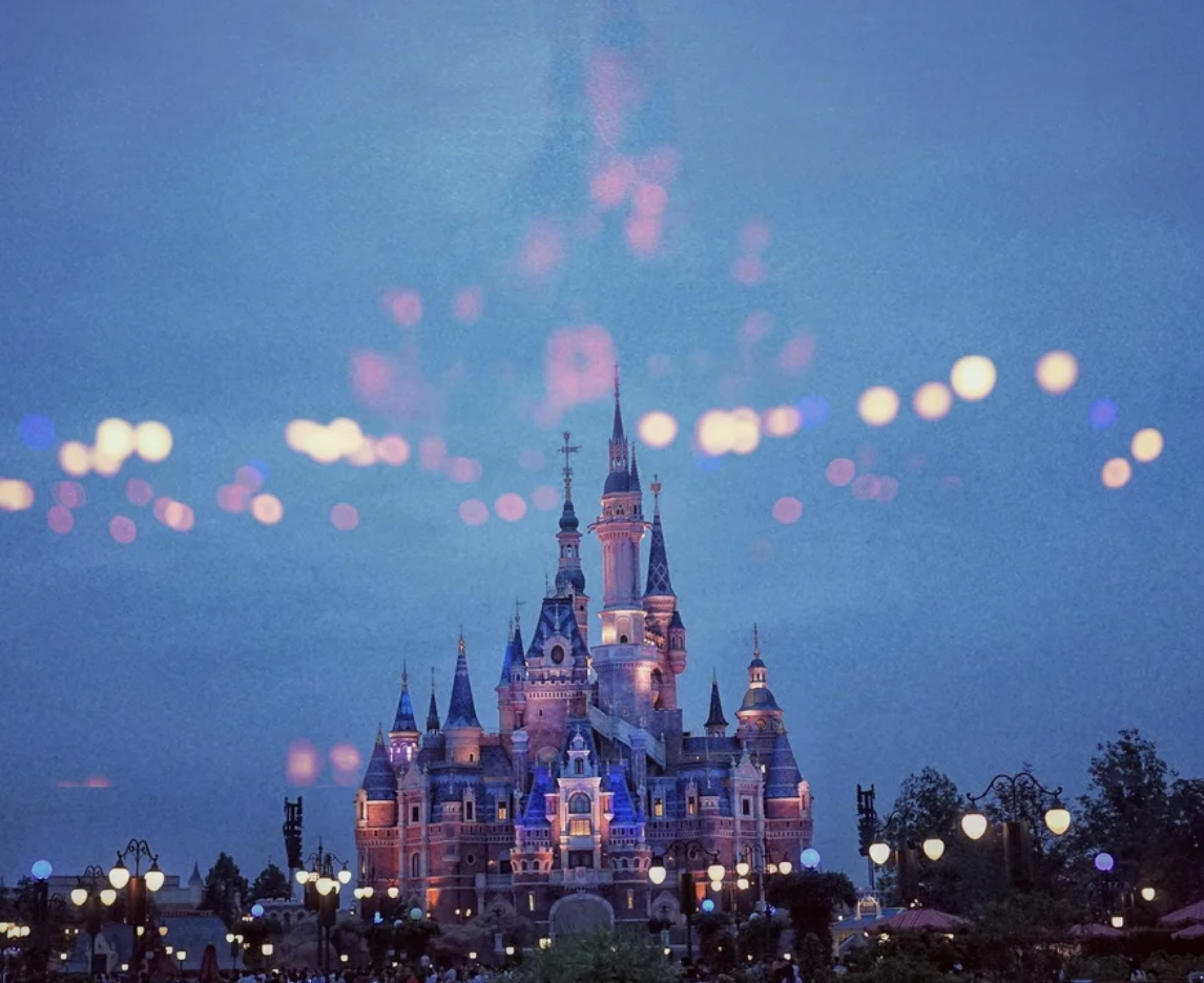 An image of the Disney castle, with bright light glare in the foreground.