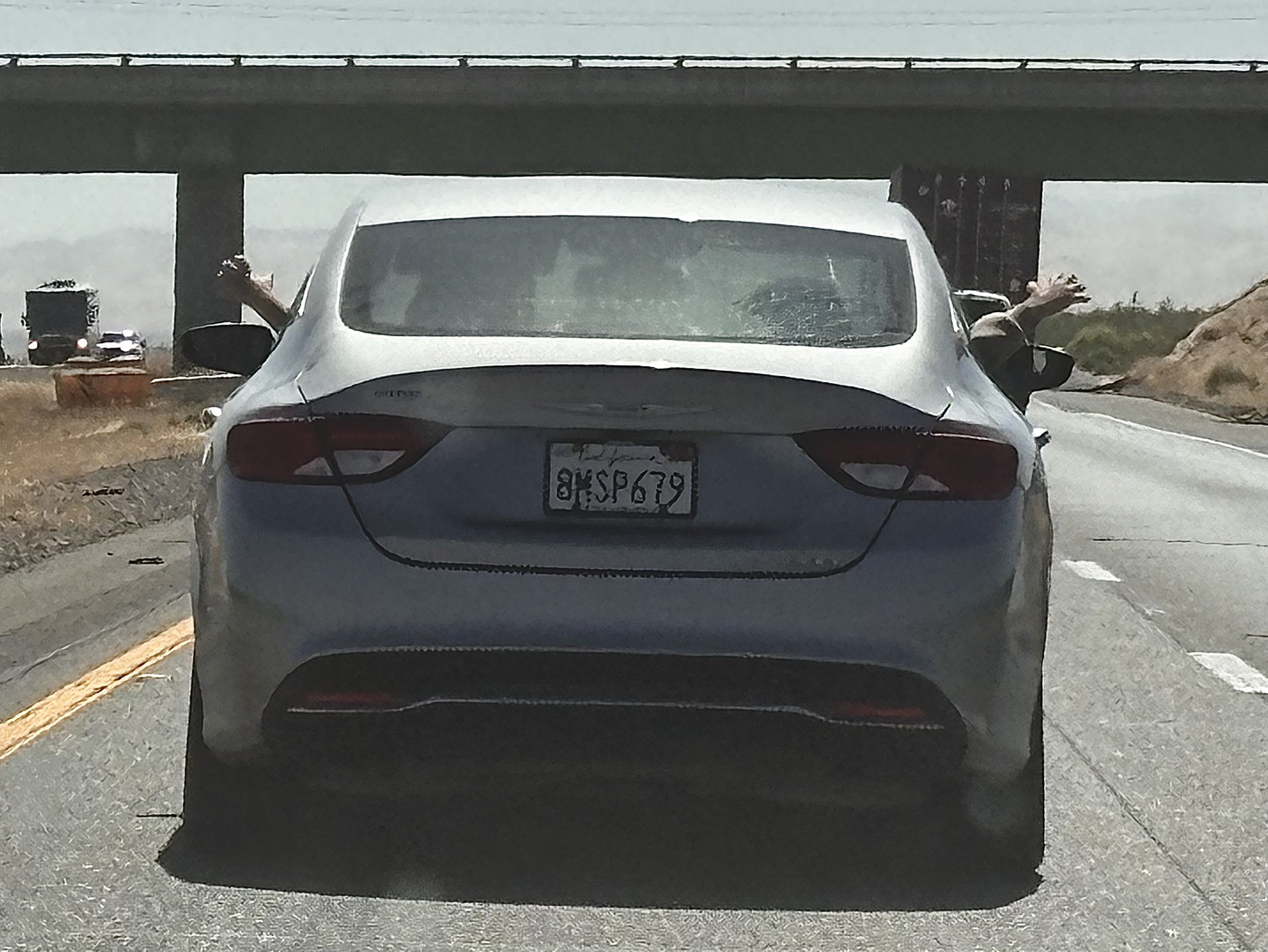 two arms sticking outside a car window