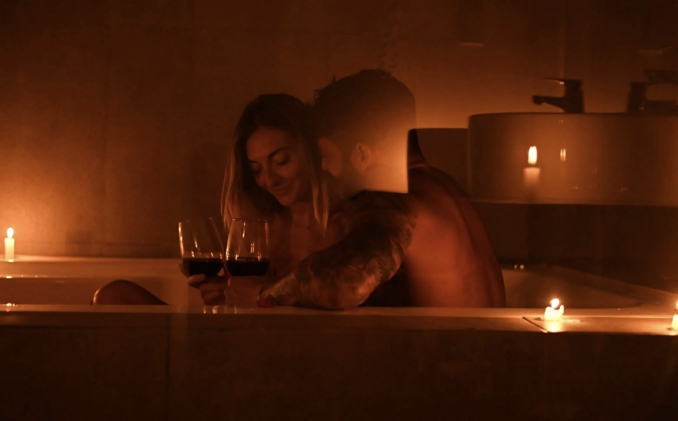 A photo of people getting intimate with one another in candlelight 