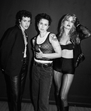An image of the band MUNA, artists Katie Gavin (she/her), Jo Maskin (she/they), and Naomi McPherson (they/them)