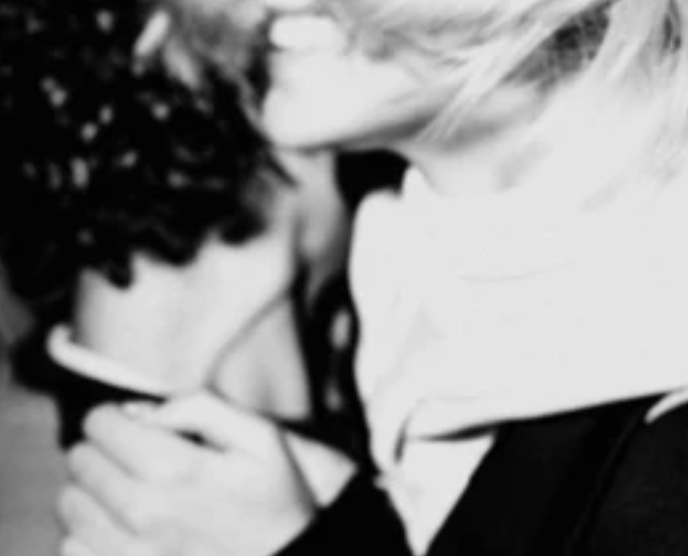 A photo of two people hugging in black and white