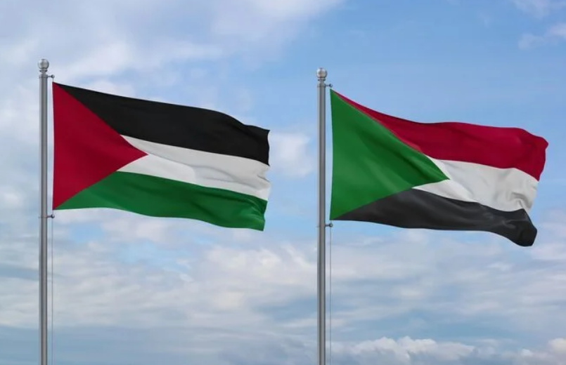 The Pakistan flag is on the left and the Sudan flag is on the right