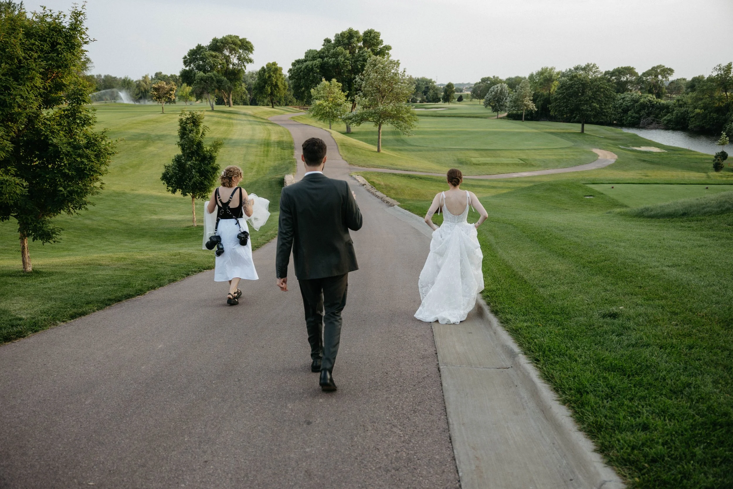 Jenna Heckel a sSioux Falls wedding photographer with a couple on their wedding day at the Sioux Falls country club.