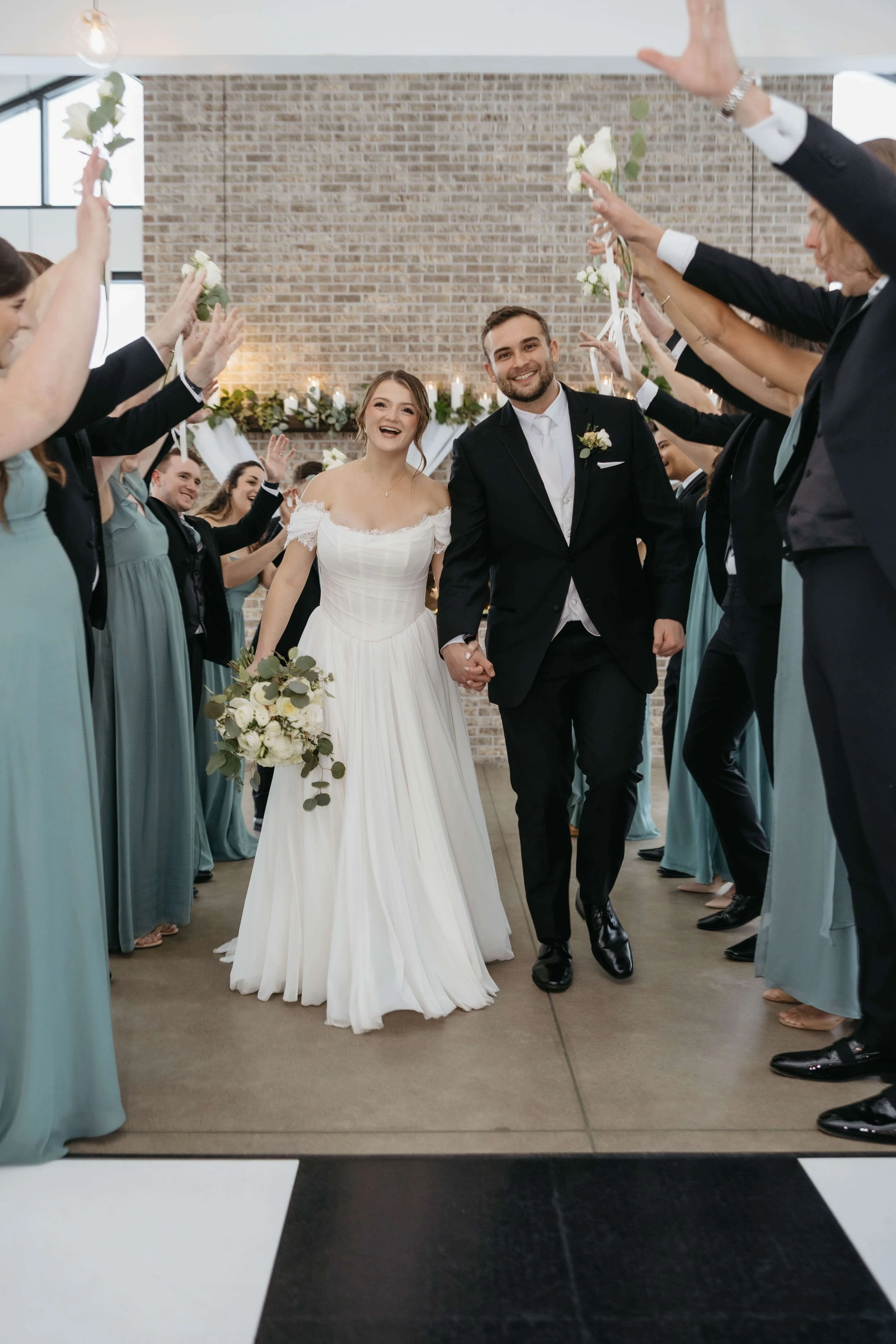 Couple doing wedding party photos at The Atrium in Sioux Falls, South Dakota. Photographed by Jenna Heckel Photography.