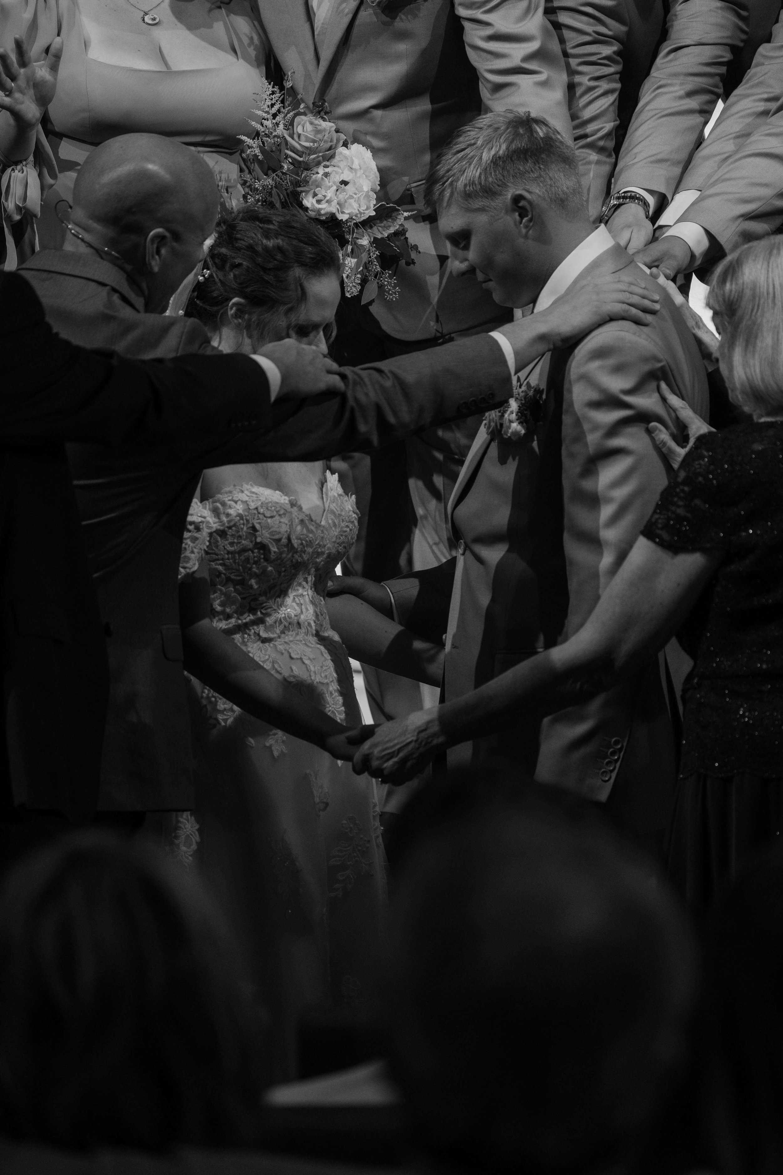 Bride and groom sharing a prayer during ceremony at Embrace church in Tea, South Dakota.