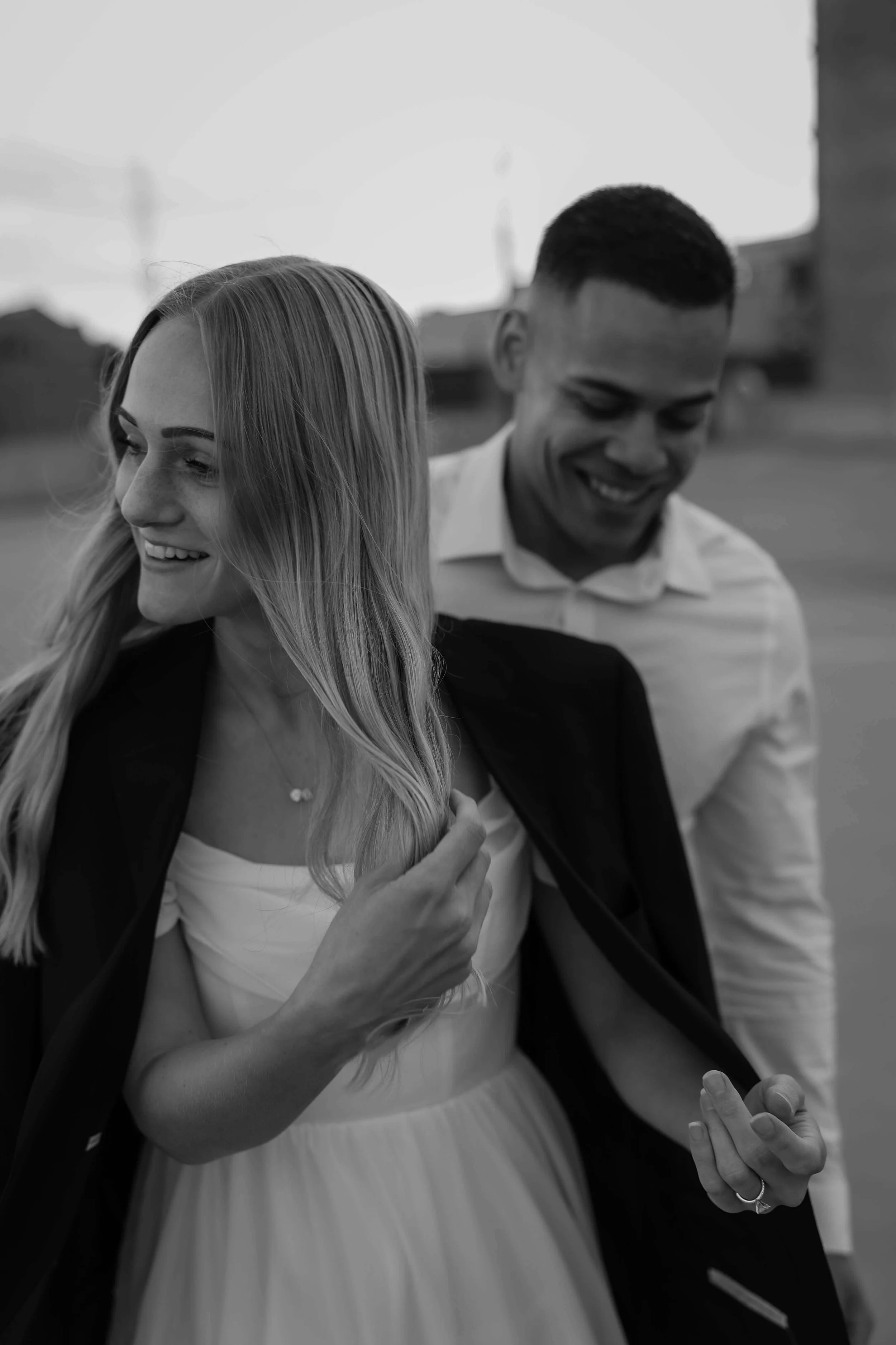 Candid black and white photo of couple during their engagement session in Sioux Falls with Jenna Heckel Photography.
