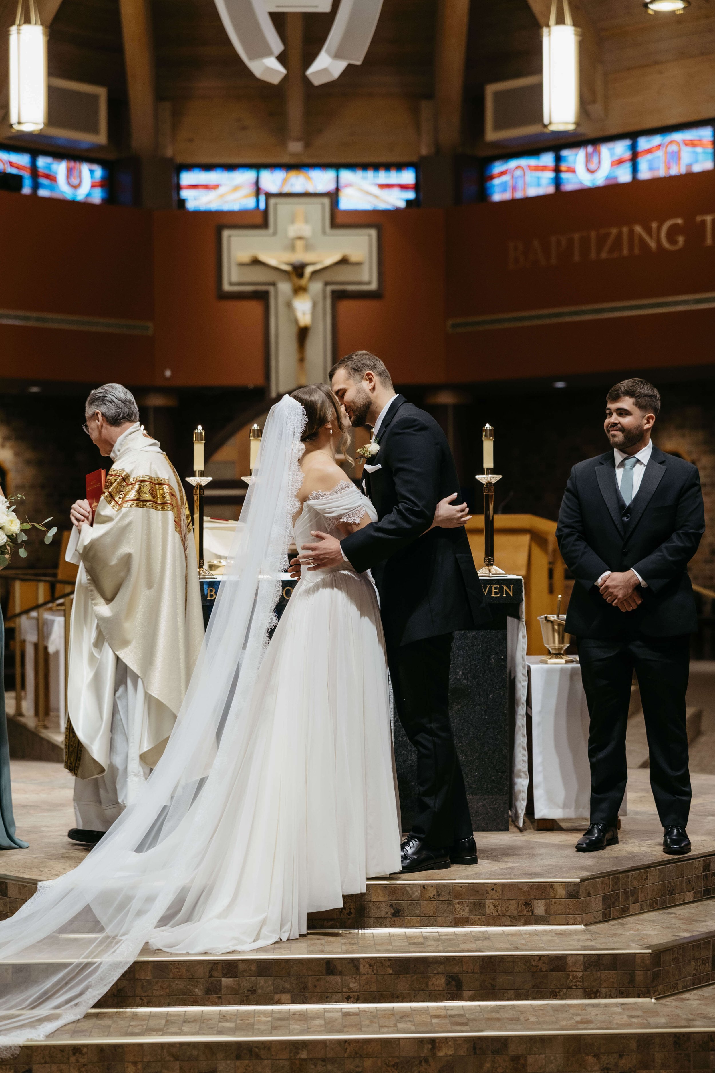 Couple during their Catholic ceremony in Sioux Falls, South Dakota. Photographed by Jenna Heckel Photography.
