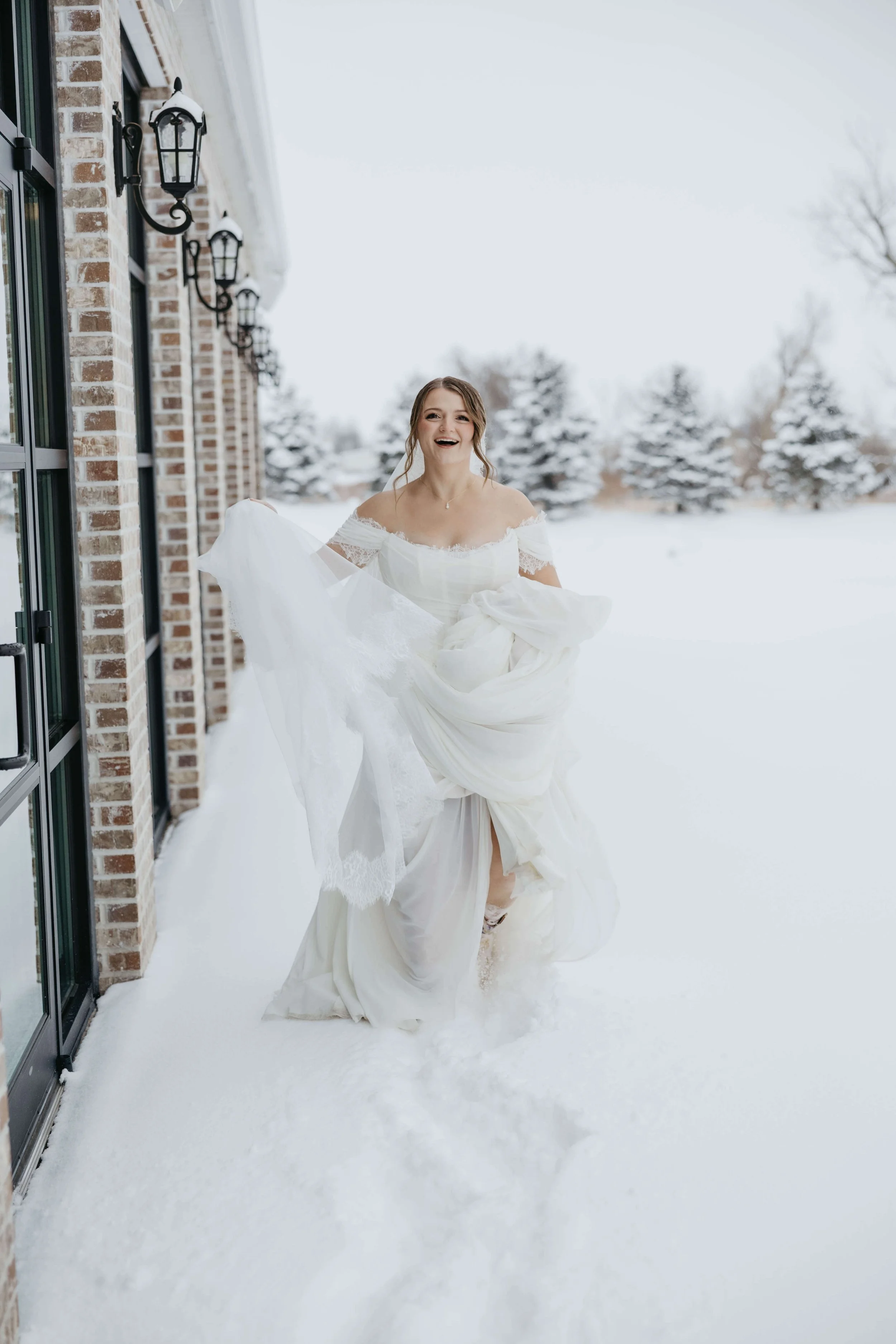 Bride on her wedding day doing candid portraits in the snow at The Atrium in Sioux Falls, South Dakota.