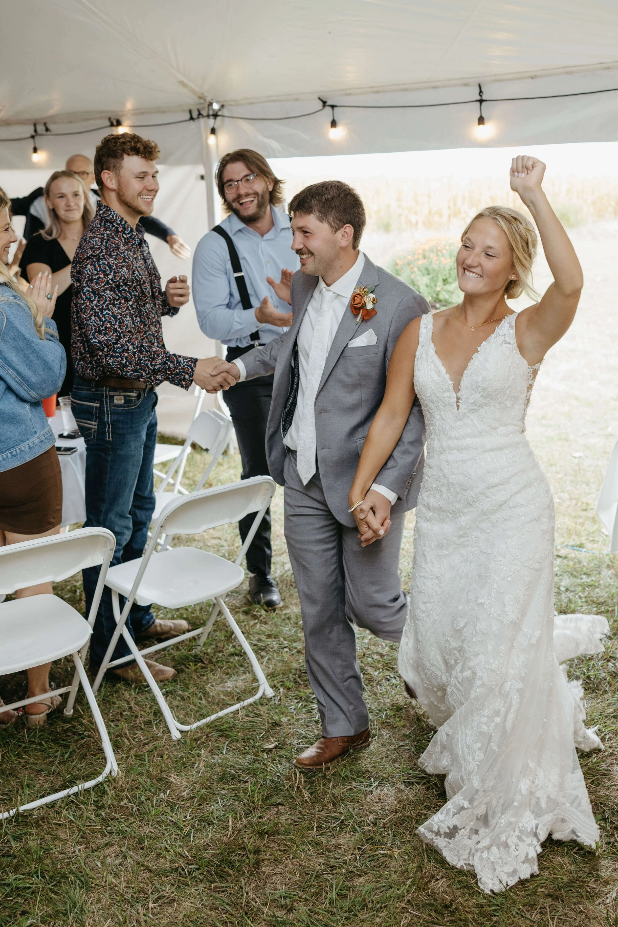 Wedding party doing fun photos near Bersford South Dakota at fall wedding. Photographed by Jenna Heckel Photography. 