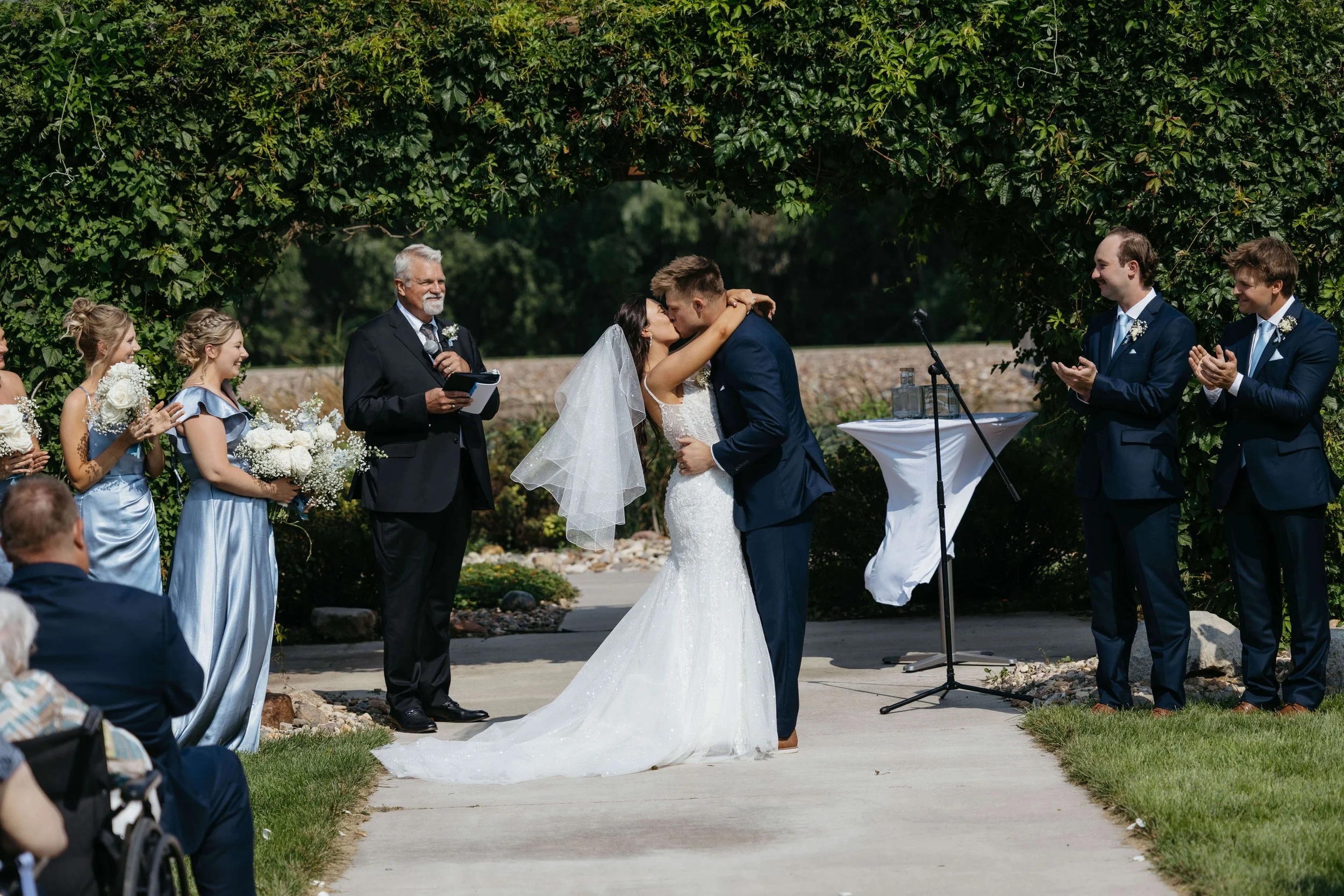Couple sharing first kiss during ceremony at JP Denmark.