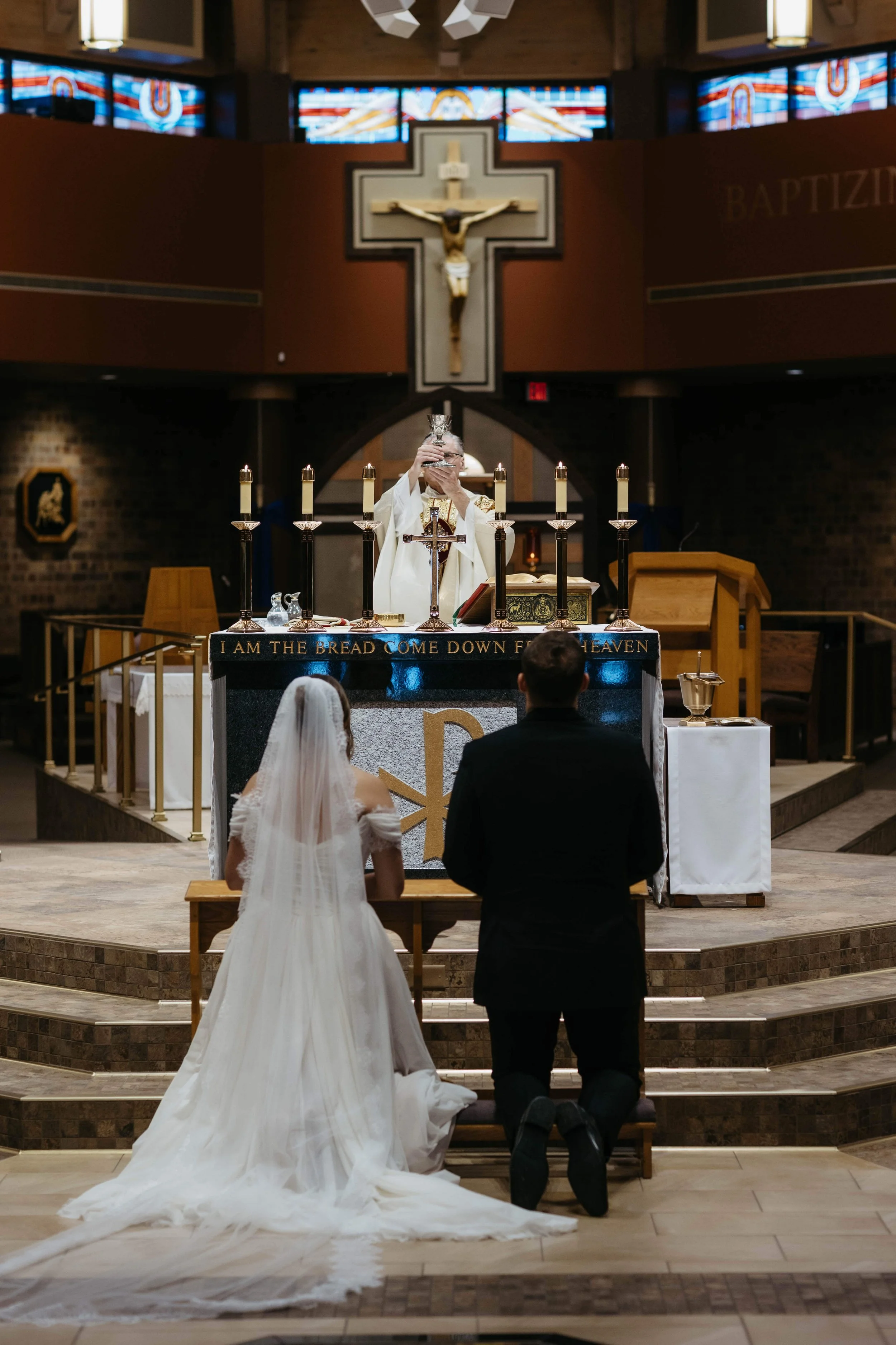 Couple during their Catholic ceremony in Sioux Falls, South Dakota. Photographed by Jenna Heckel Photography.