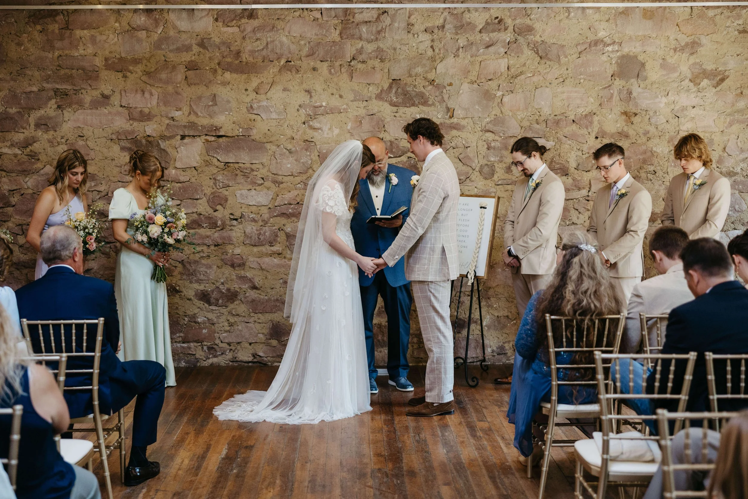Couple during ceremony at Mosaic wedding venue in downtown Sioux Falls photographed by Jenna Heckel Photography. 