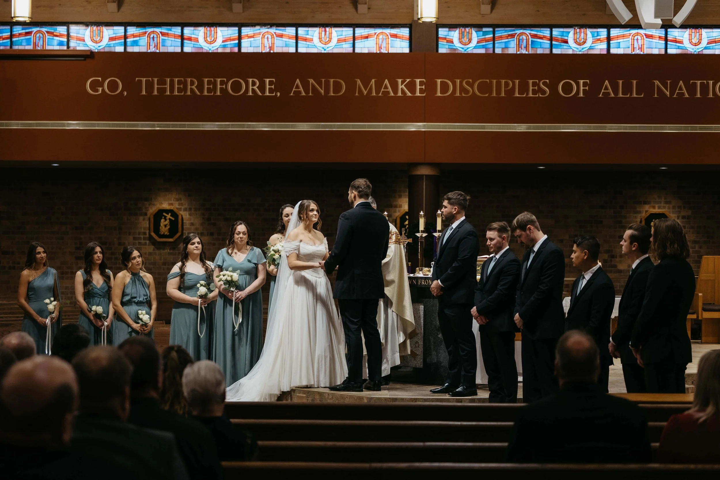 Couple during their Catholic ceremony in Sioux Falls, South Dakota. Photographed by Jenna Heckel Photography.