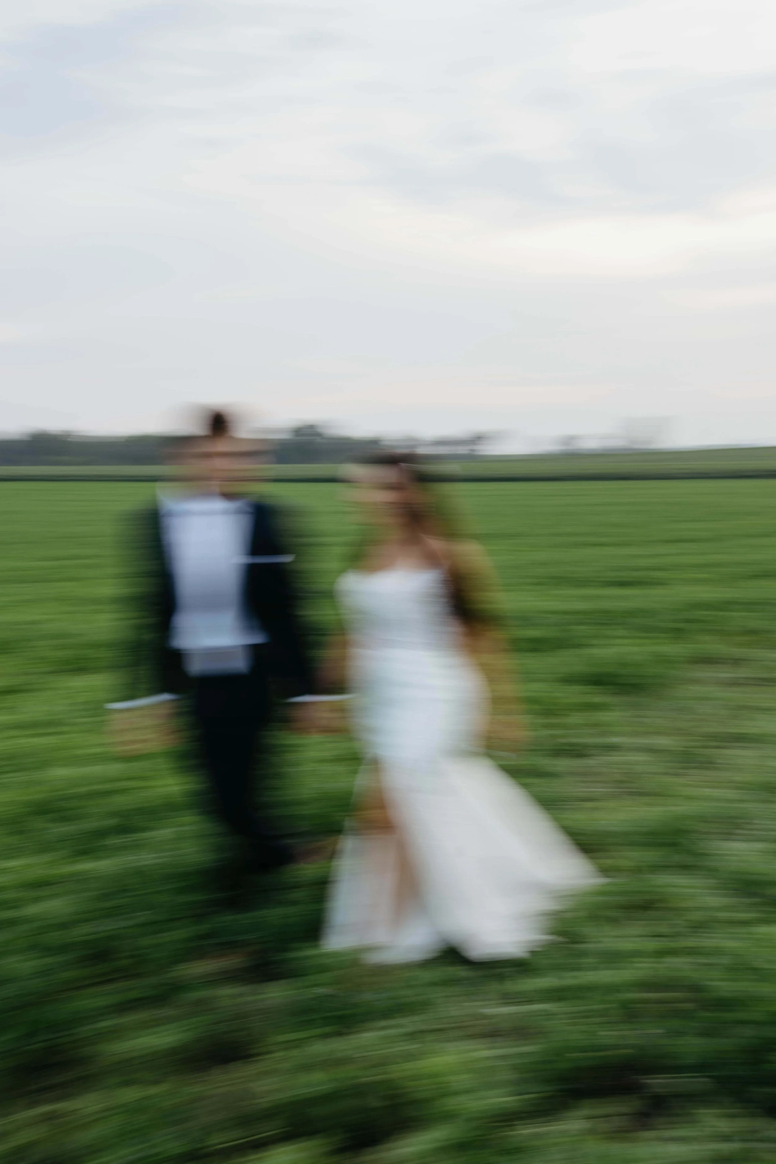 Couple taking sunset portraits in Sioux Falls South Dakota on their wedding day photographed by Jenna Heckel Photography.