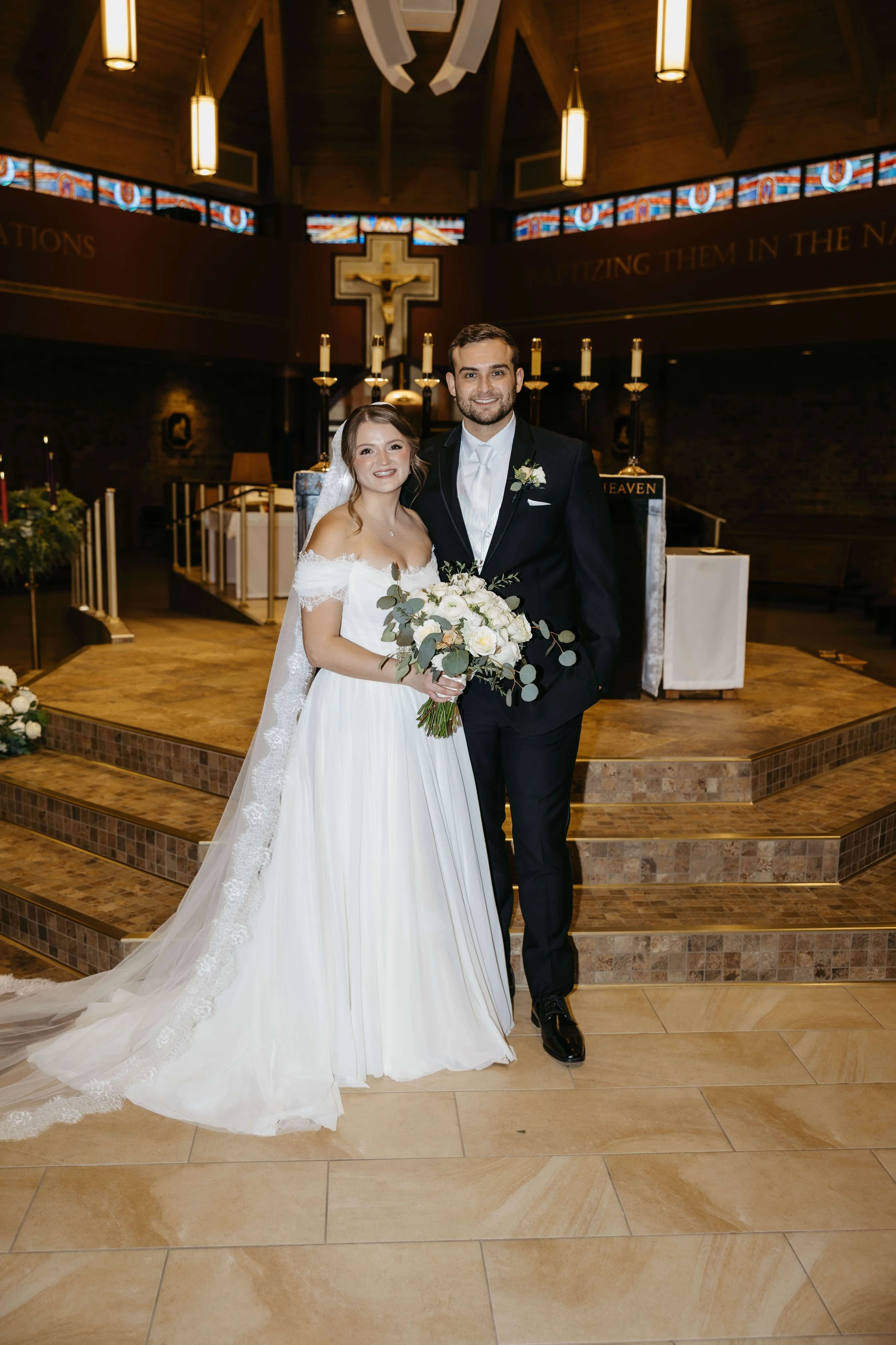 Couple during their Catholic ceremony in Sioux Falls, South Dakota. Photographed by Jenna Heckel Photography.