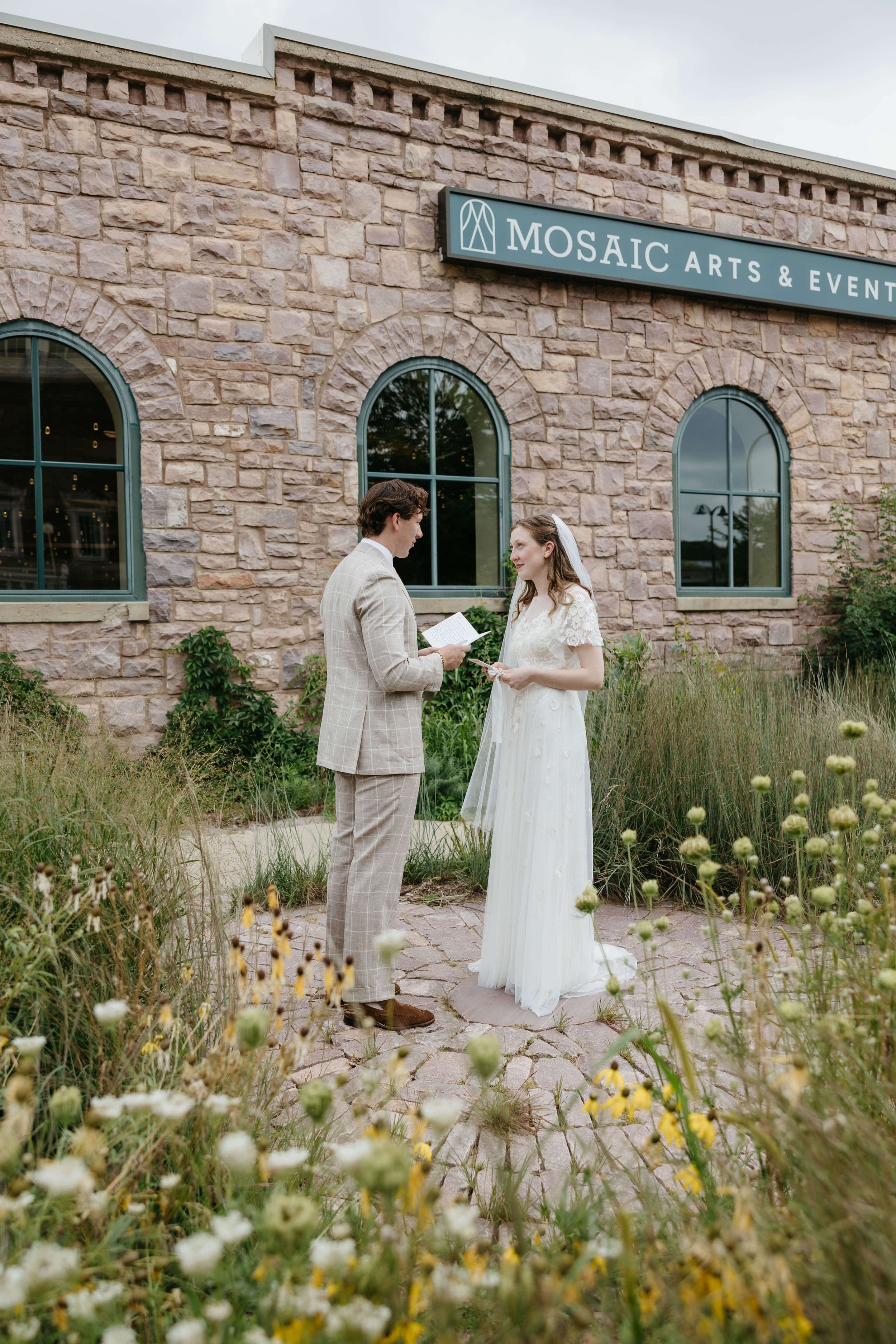 Couple reading vows at Mosaic wedding venue in downtown Sioux Falls photographed by Jenna Heckel Photography. 