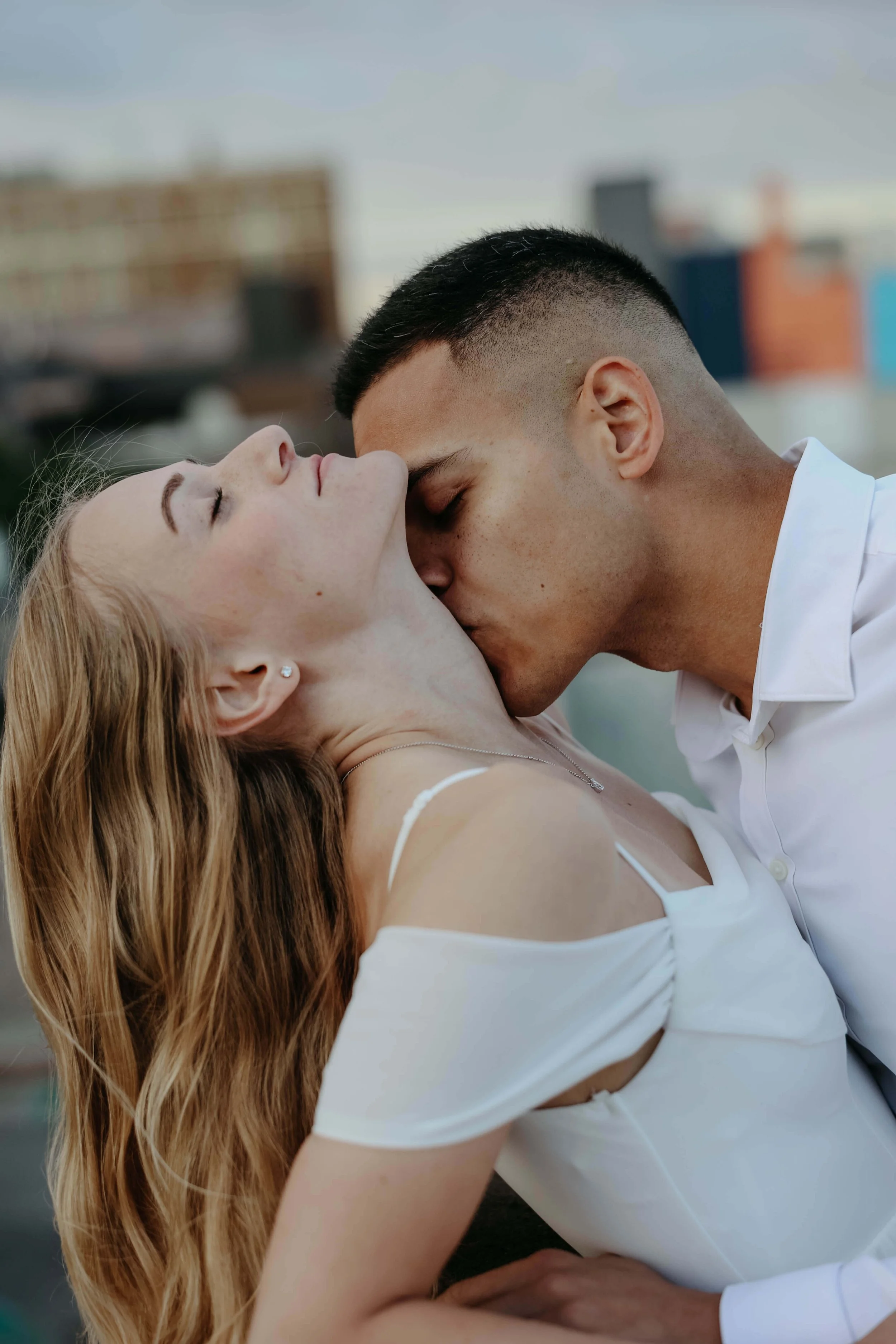 Couple having an intimate moment during engagement session in downtown Sioux Falls.
