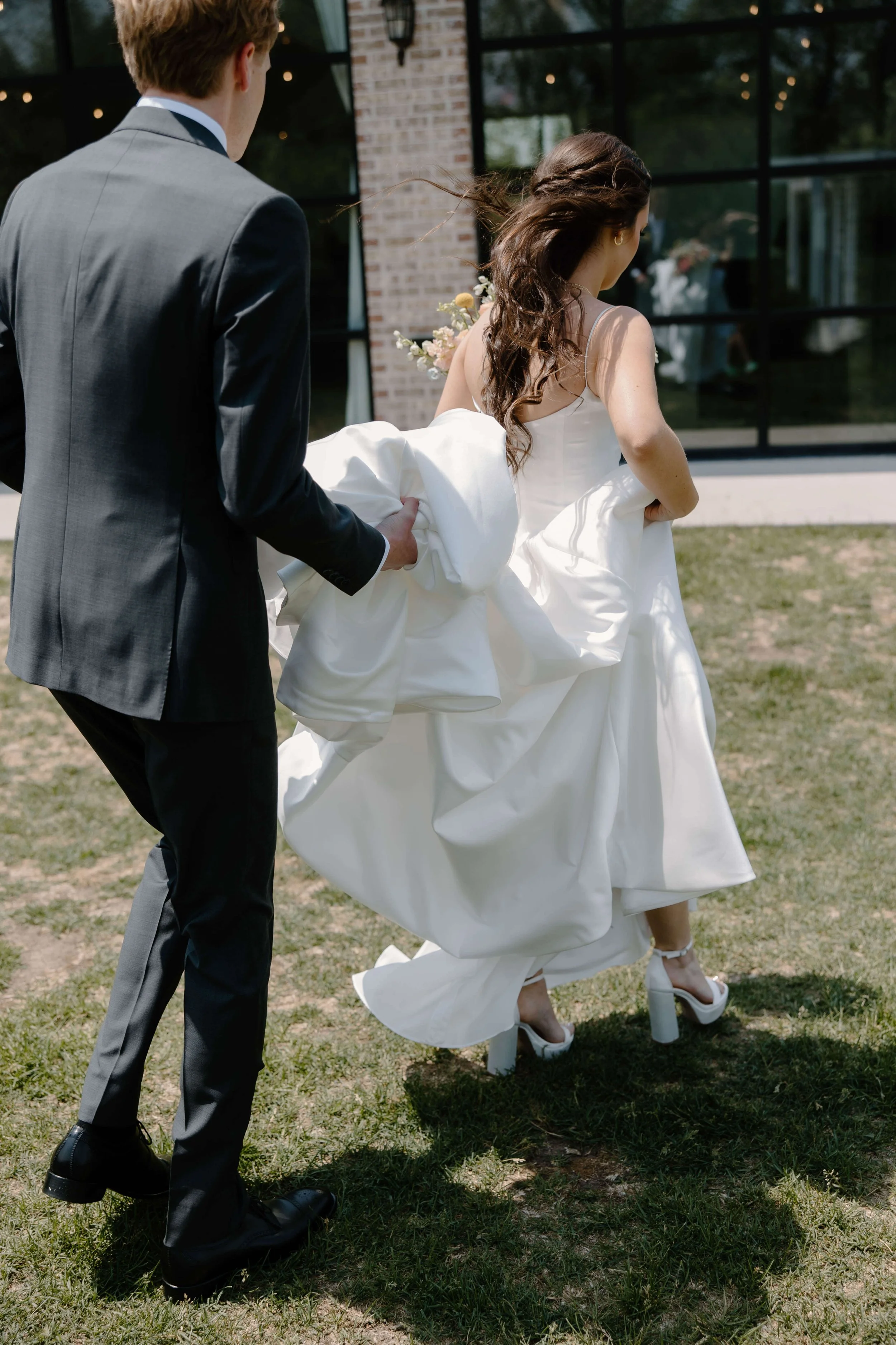 Candid portraits of bride and groom at summer wedding on their wedding day at The Atrium in Sioux Falls, photographed by Jenna Heckel Photography.