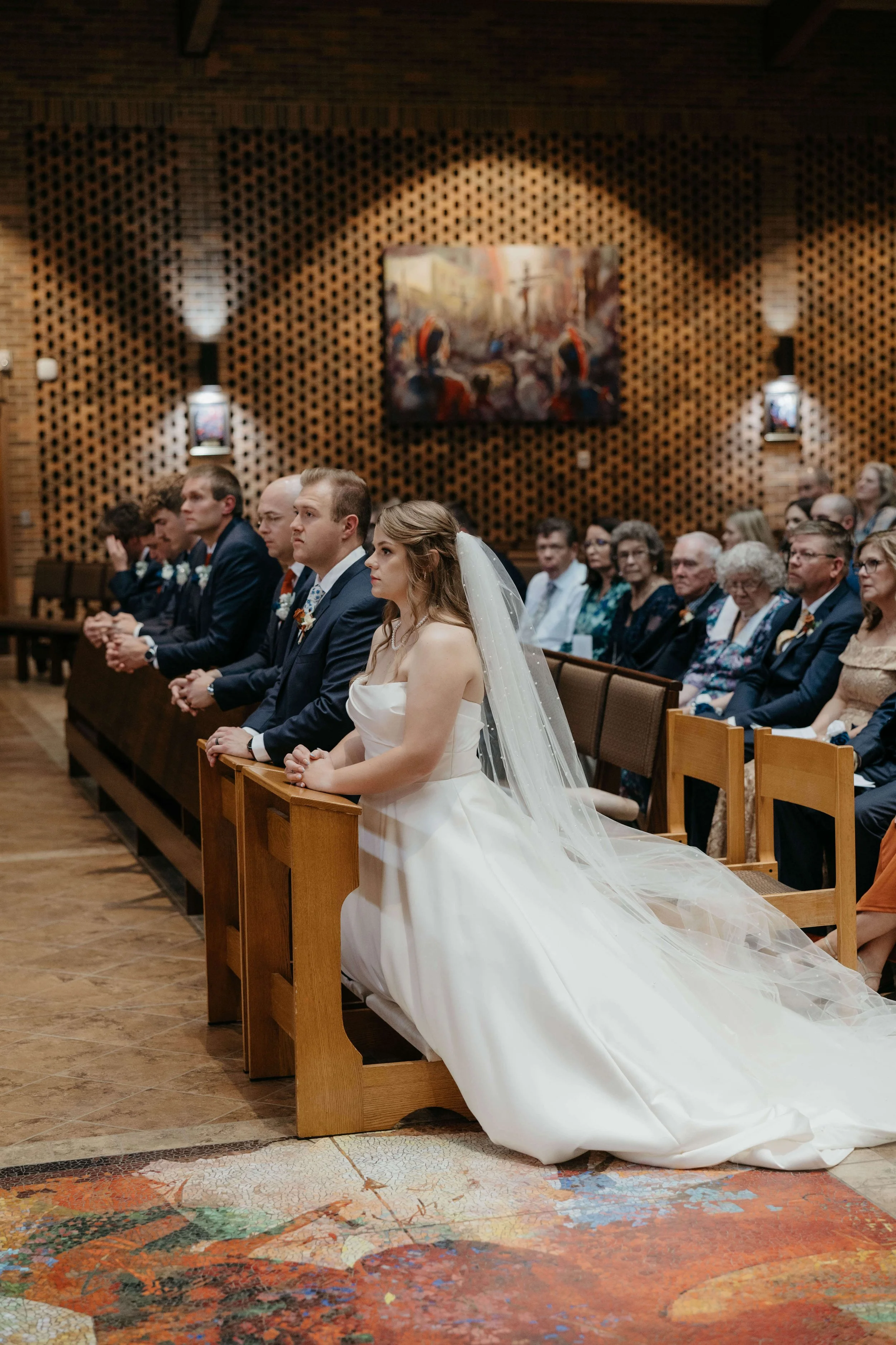 Couple during their Catholic ceremony in Sioux Falls, South Dakota. Photographed by Jenna Heckel Photography.