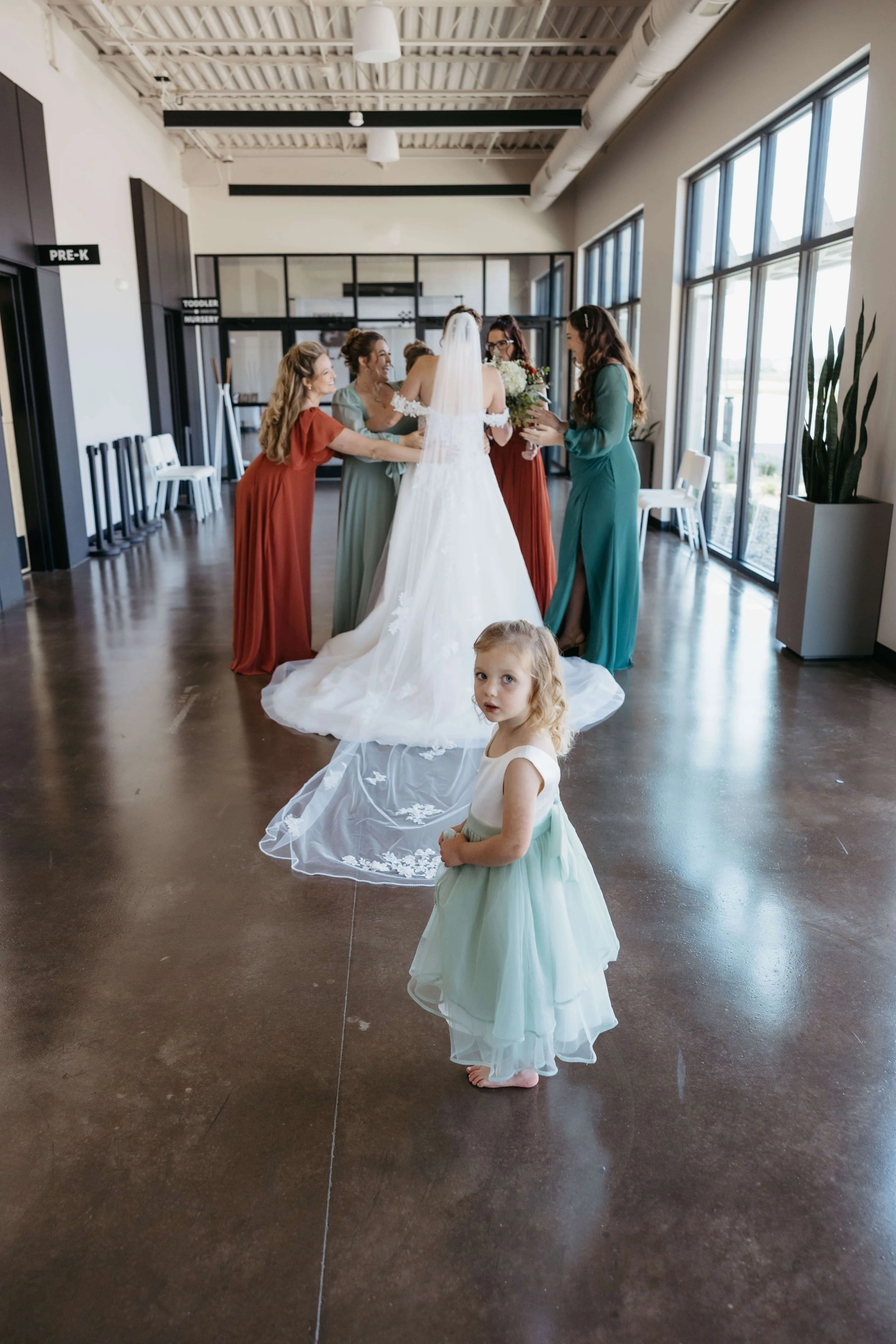 Bride doing first look with her bridesmaids at embrace church in Tea, South Dakota.