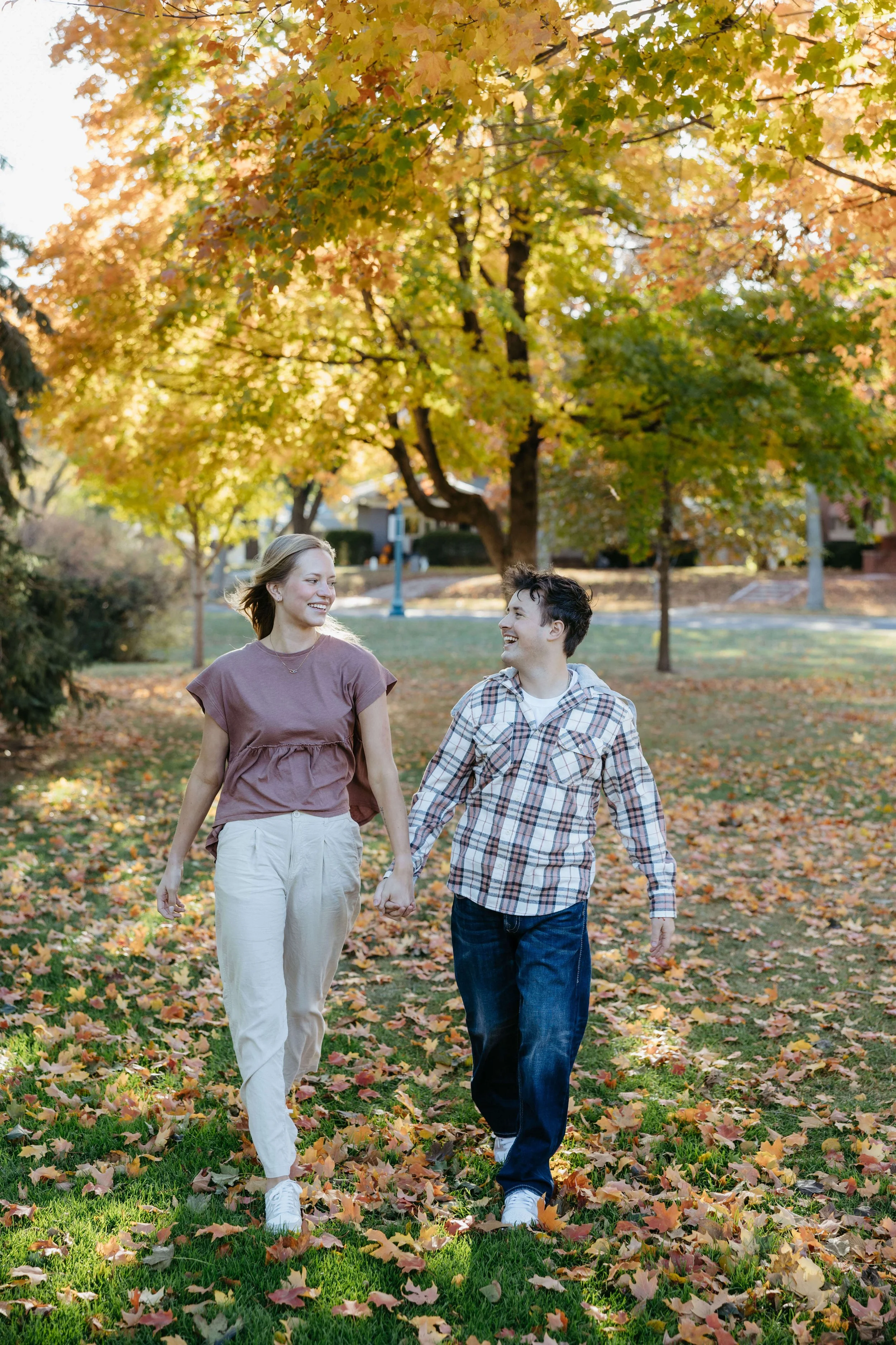 Couple doing fall engagement photos at McKennan park in Sioux Falls with Jenna Heckel Photography.