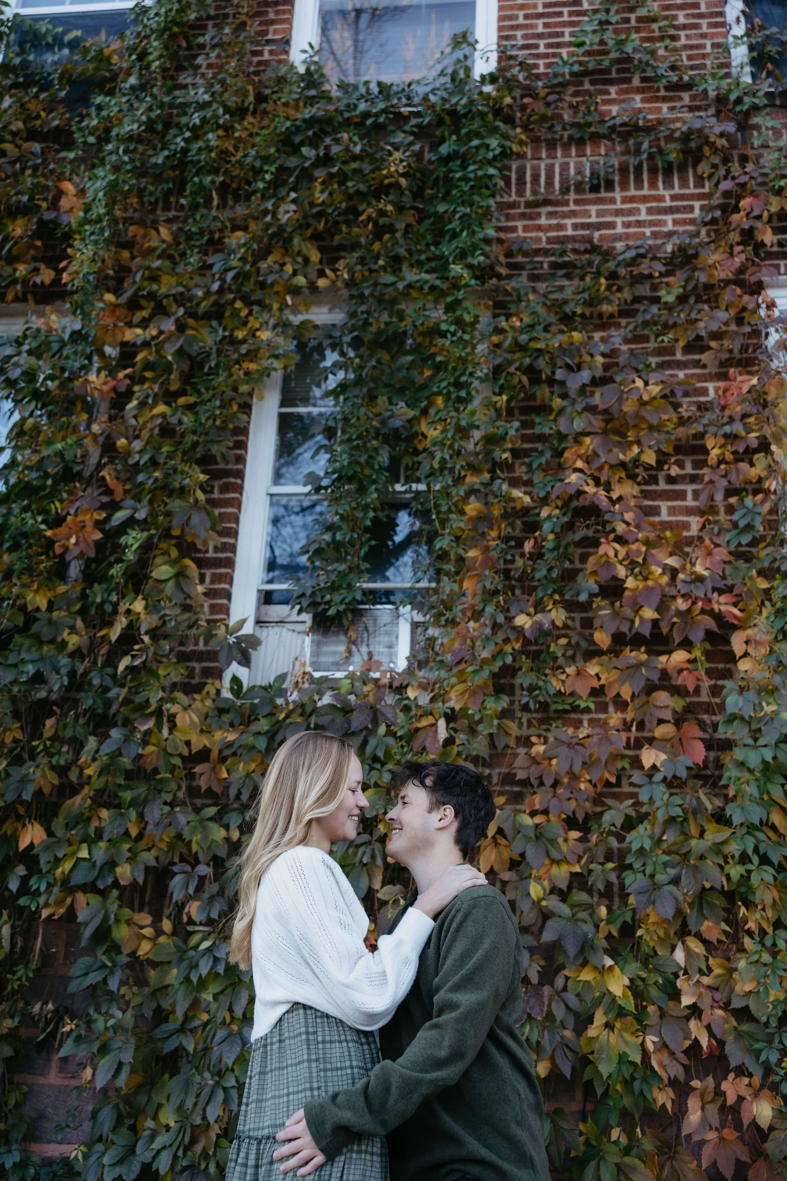 Couple doing fall engagement photos at downtown in Sioux Falls with Jenna Heckel Photography.