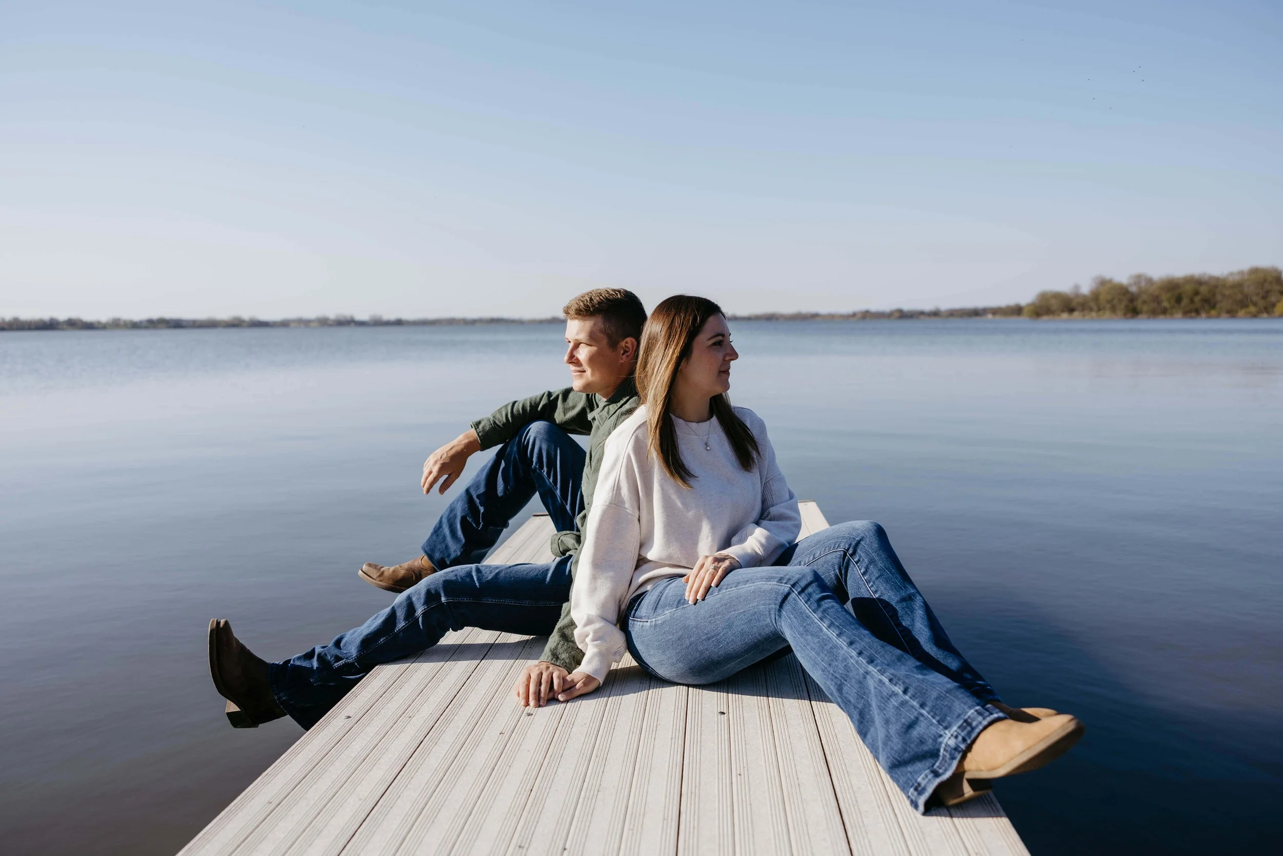 Couple holding hands at their engagement session at Prairie shores Resort in Madison SD, Photographed by Jenna Heckel photography.