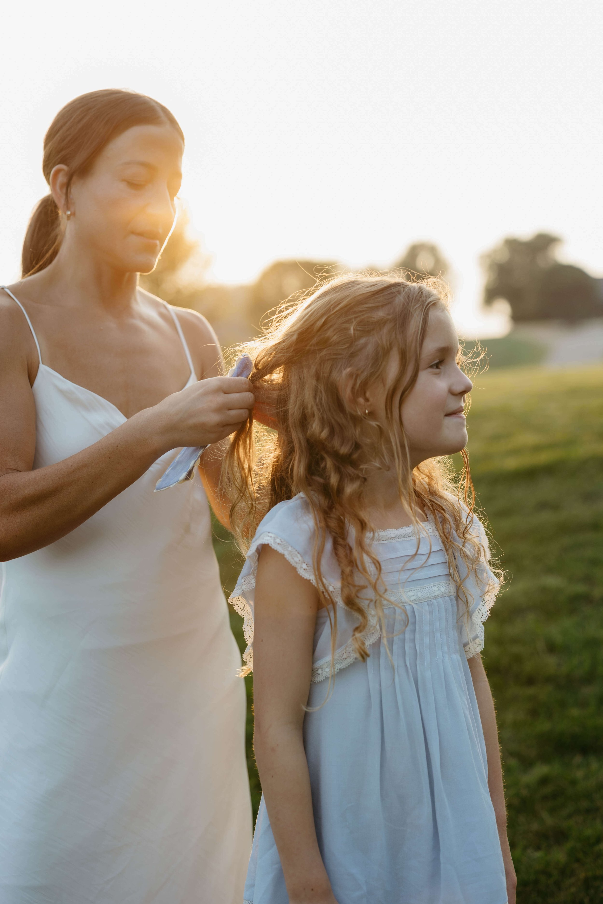 Mother and daughter during family photo session at sunset near Brandon South Dakota.
