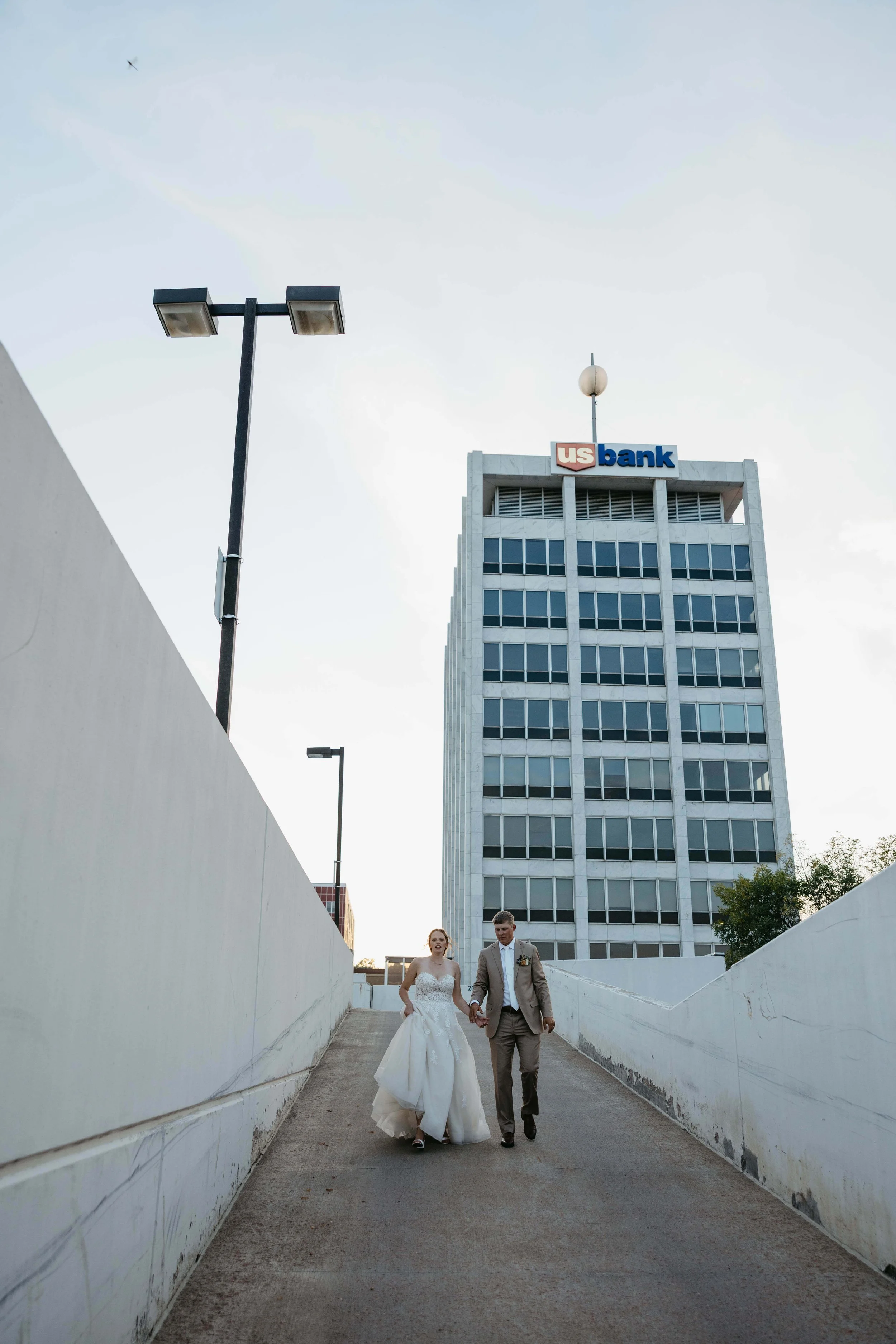 Couple taking sunset portraits in downtown Sioux Falls. Photographed by Jenna Heckel Photography. 