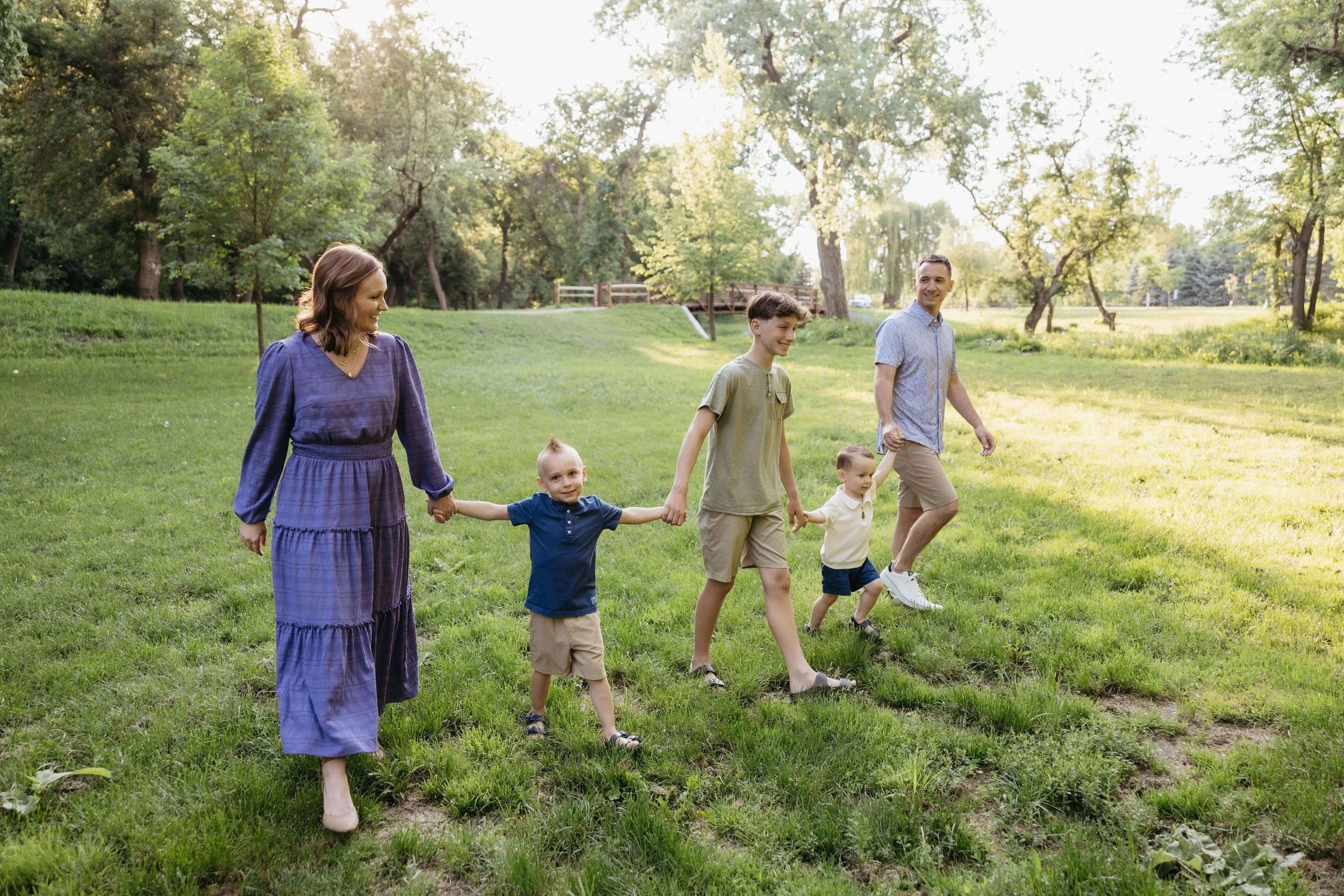 Family doing candid family portraits at Perry Nature Area near Sioux Falls, South Dakota. Photographed by Jenna Heckel Photography.