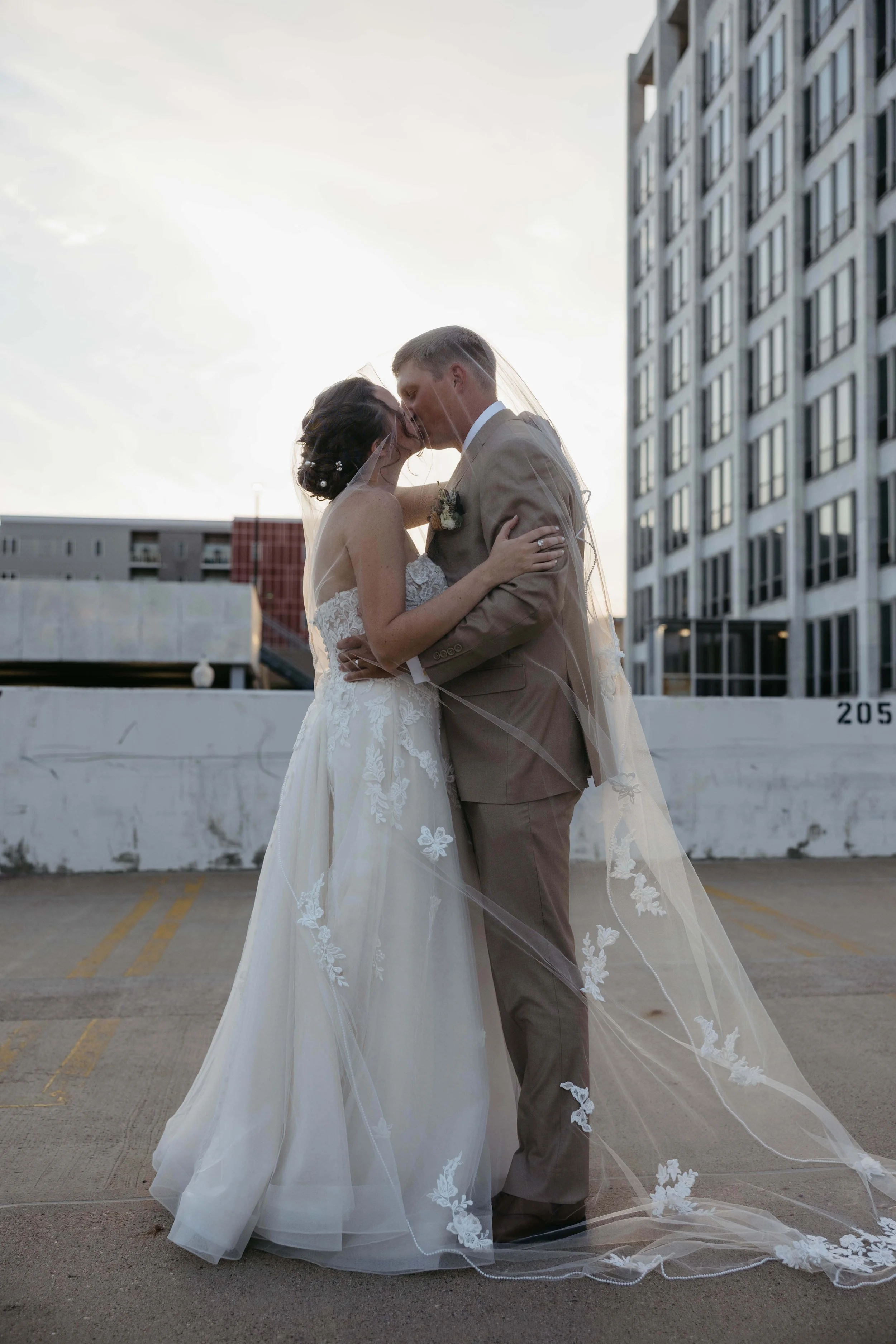 Couple taking sunset portraits in downtown Sioux Falls. Photographed by Jenna Heckel Photography. 