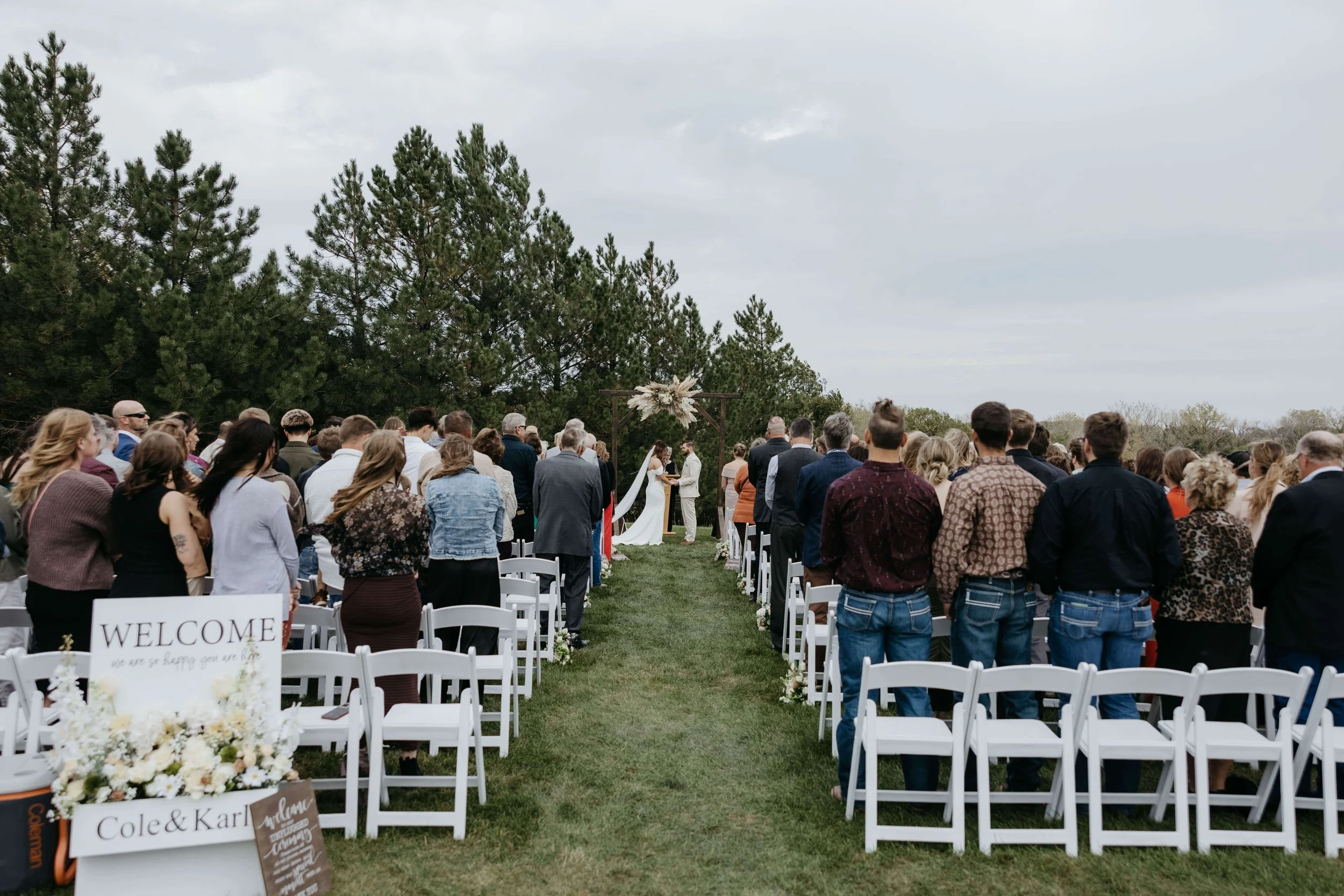 Bride and groom during their ceremony at Granite Springs Lodge near Mitchell South Dakota photographed by Jenna Heckel Photography.