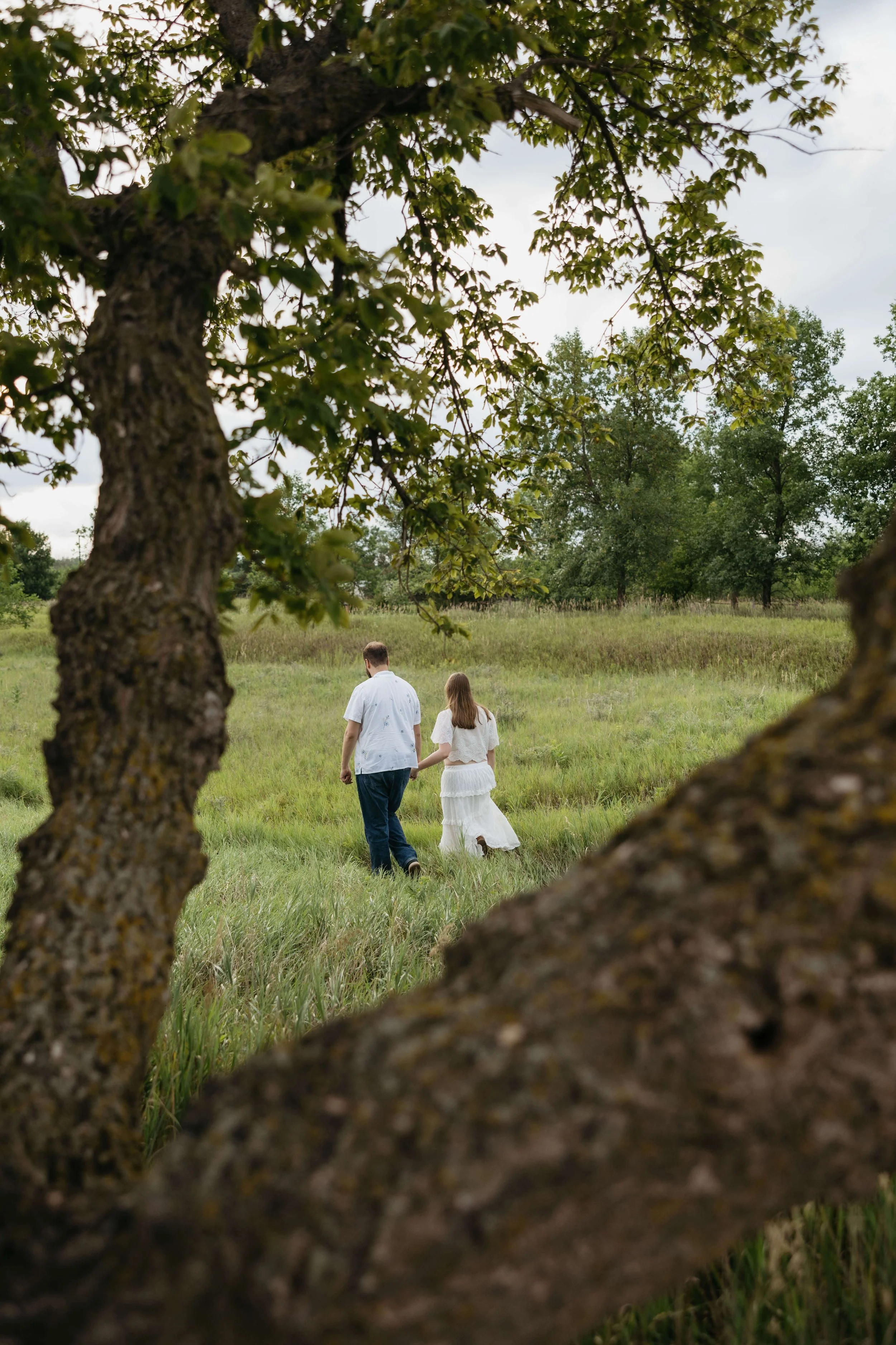 Couple doing maternity photos at sunset at Mary Jo Wegner near Sioux Falls, South Dakota. Photographed by Jenna Heckel Photography.