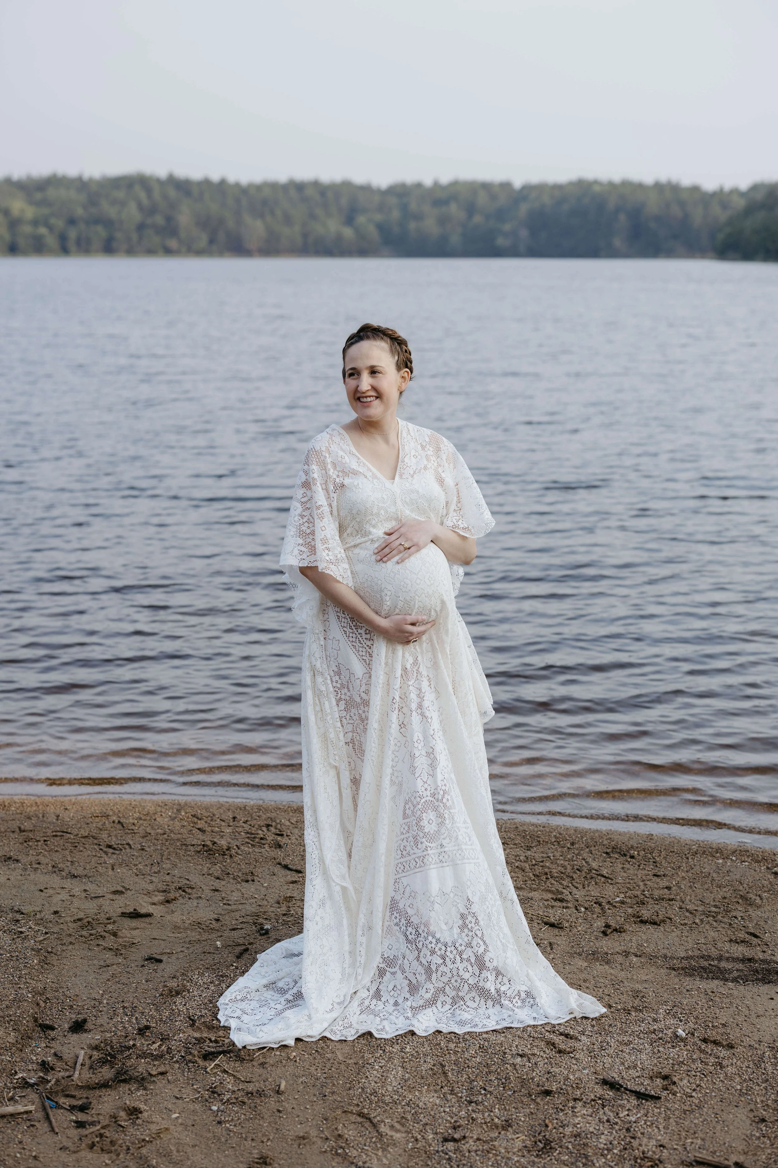 Mother doing maternity photos at Lake Alvin near Sioux Falls, South Dakota. Photographed by Jenna Heckel Photography.