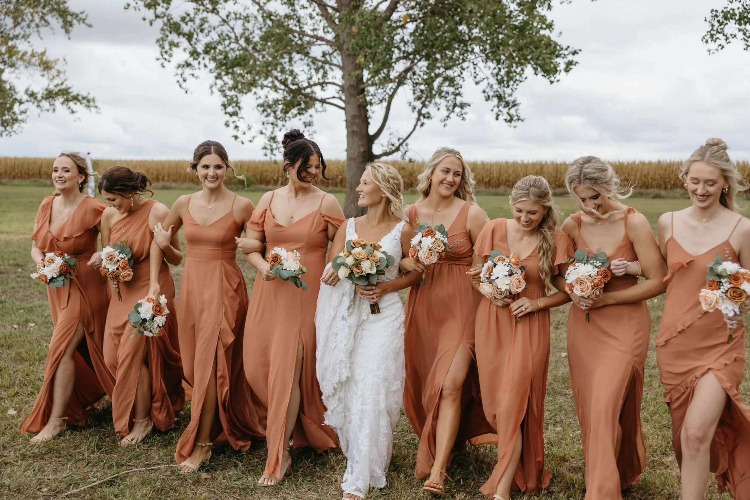 Wedding party doing fun photos near Bersford South Dakota at fall wedding. Photographed by Jenna Heckel Photography. 