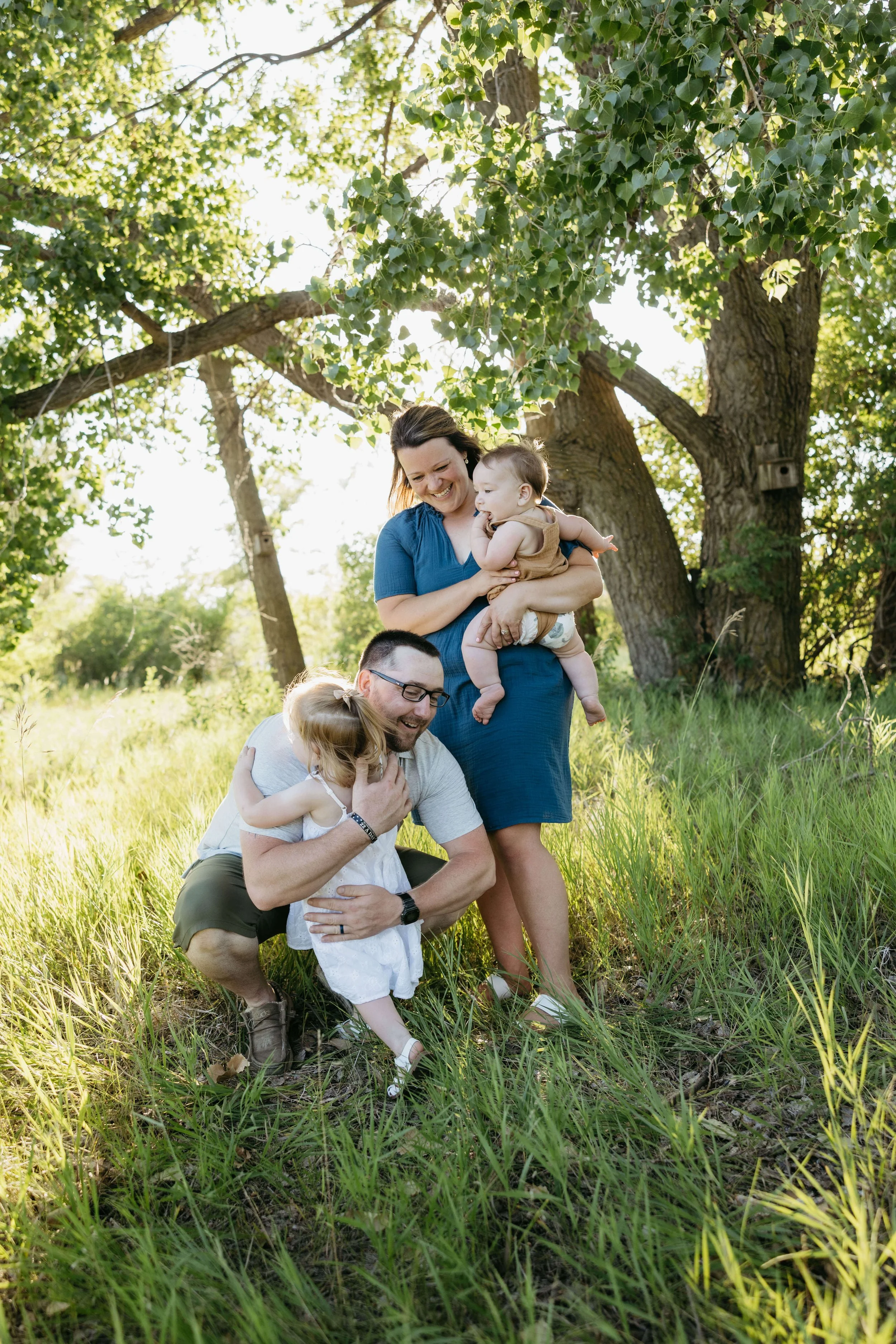 Family doing summer family pictures near Brookings, South Dakota at sunset. Photographed by Jenna Heckel Photography.