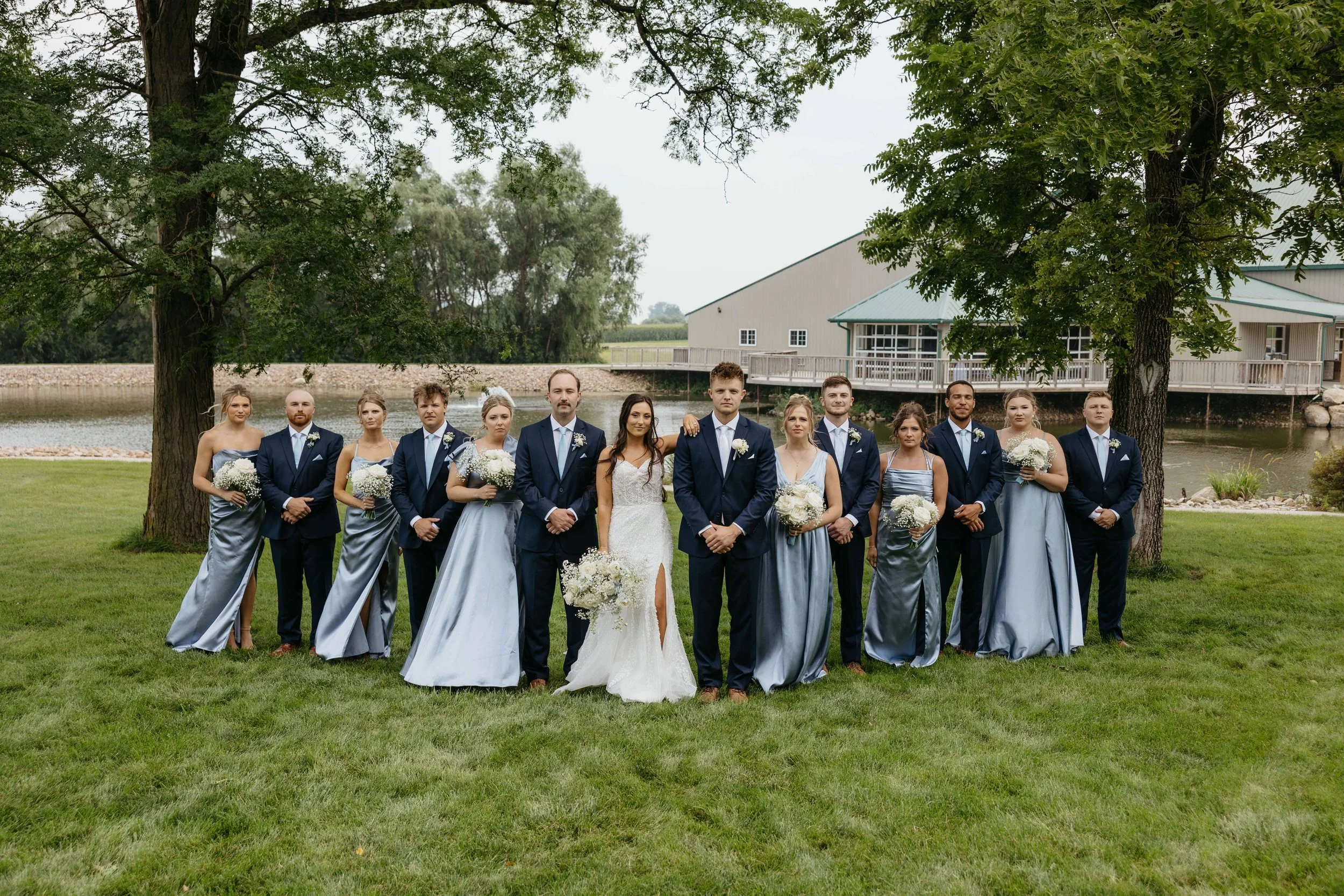 Couple taking wedding party photos at JP Denmark. 