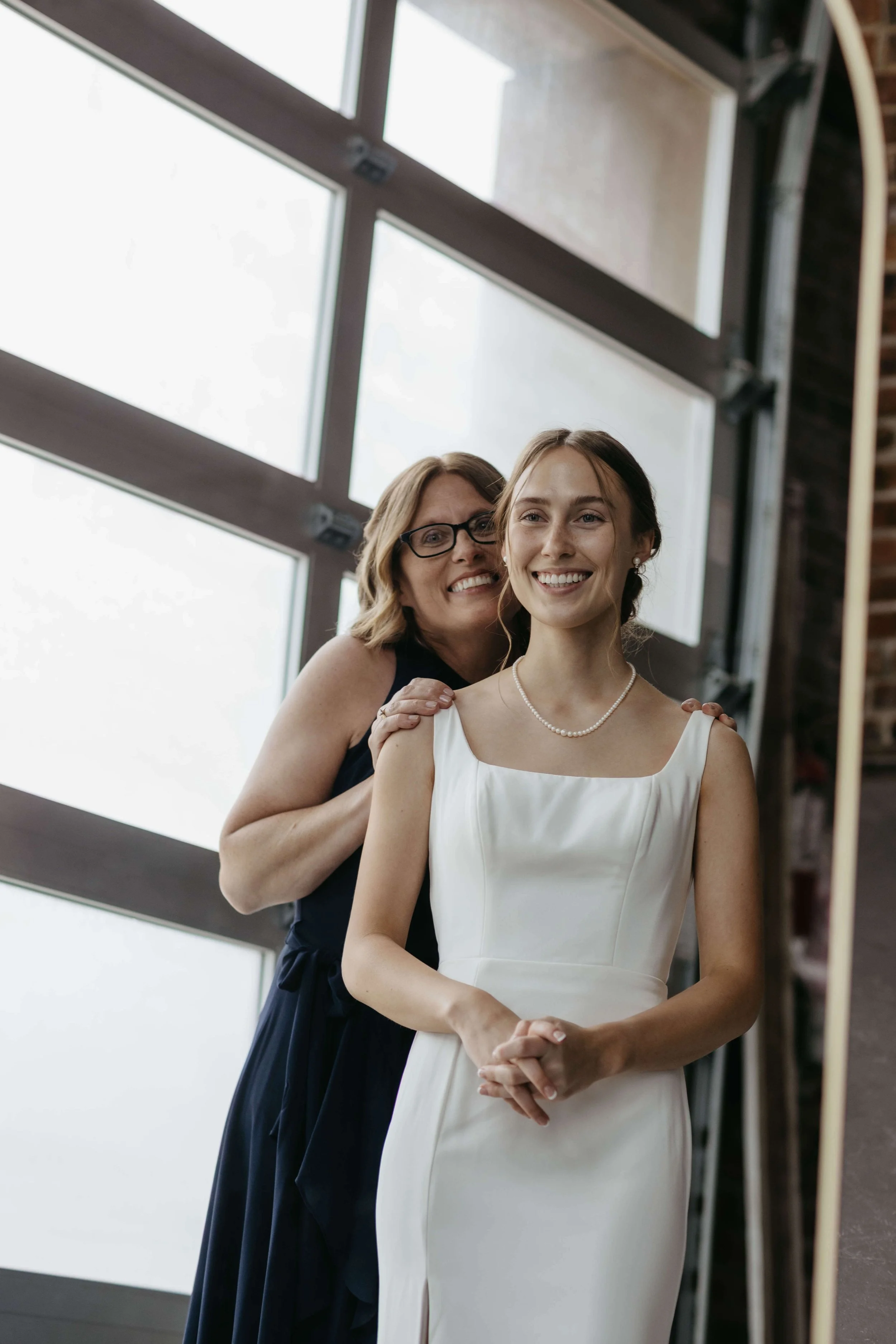 Bride with her mom getting ready on her wedding day in Yankton South Dakota. 